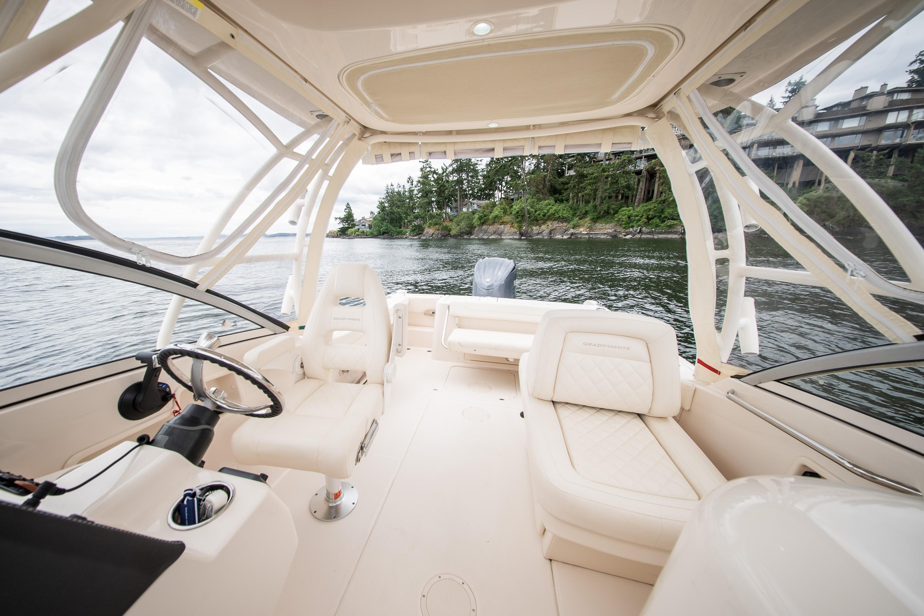 2023 Grady-White Freedom 235 boat interior with luxurious seating on a scenic lake.