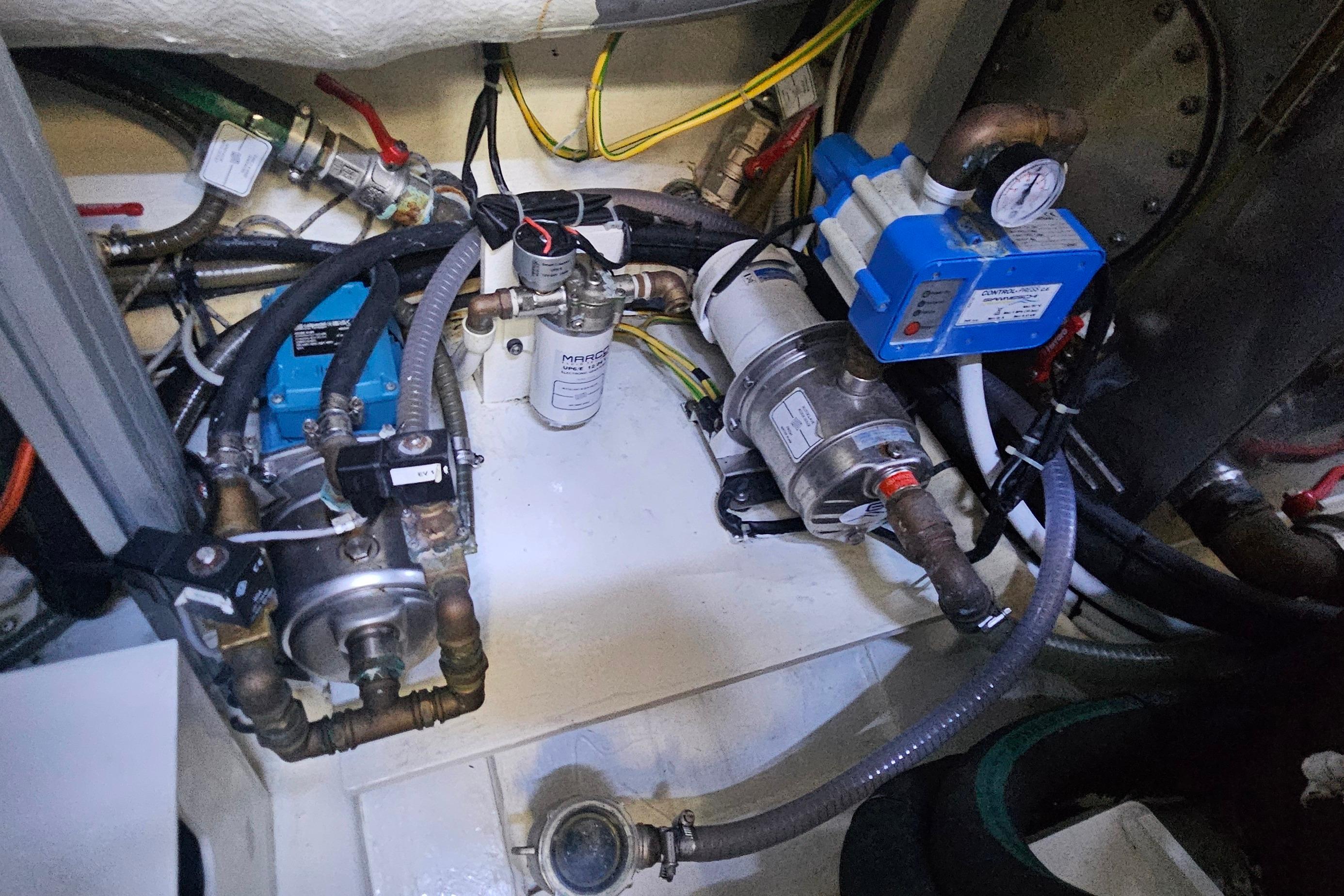 Engine room of a 2022 Ferretti Yachts 550, showcasing mechanical components and wiring.