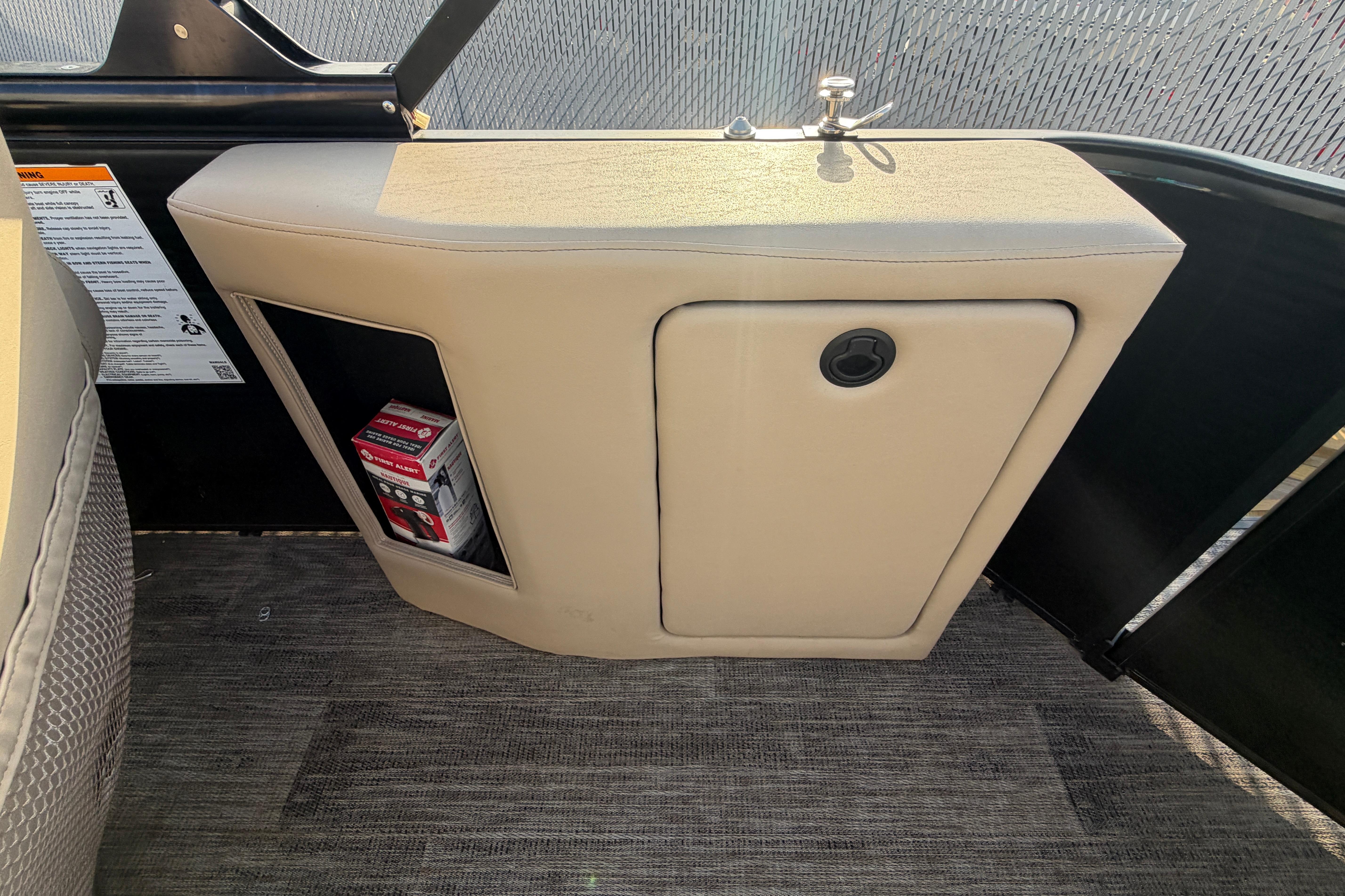 2023 Godfrey Sweetwater 2286 C boat interior storage compartment with beige upholstery.