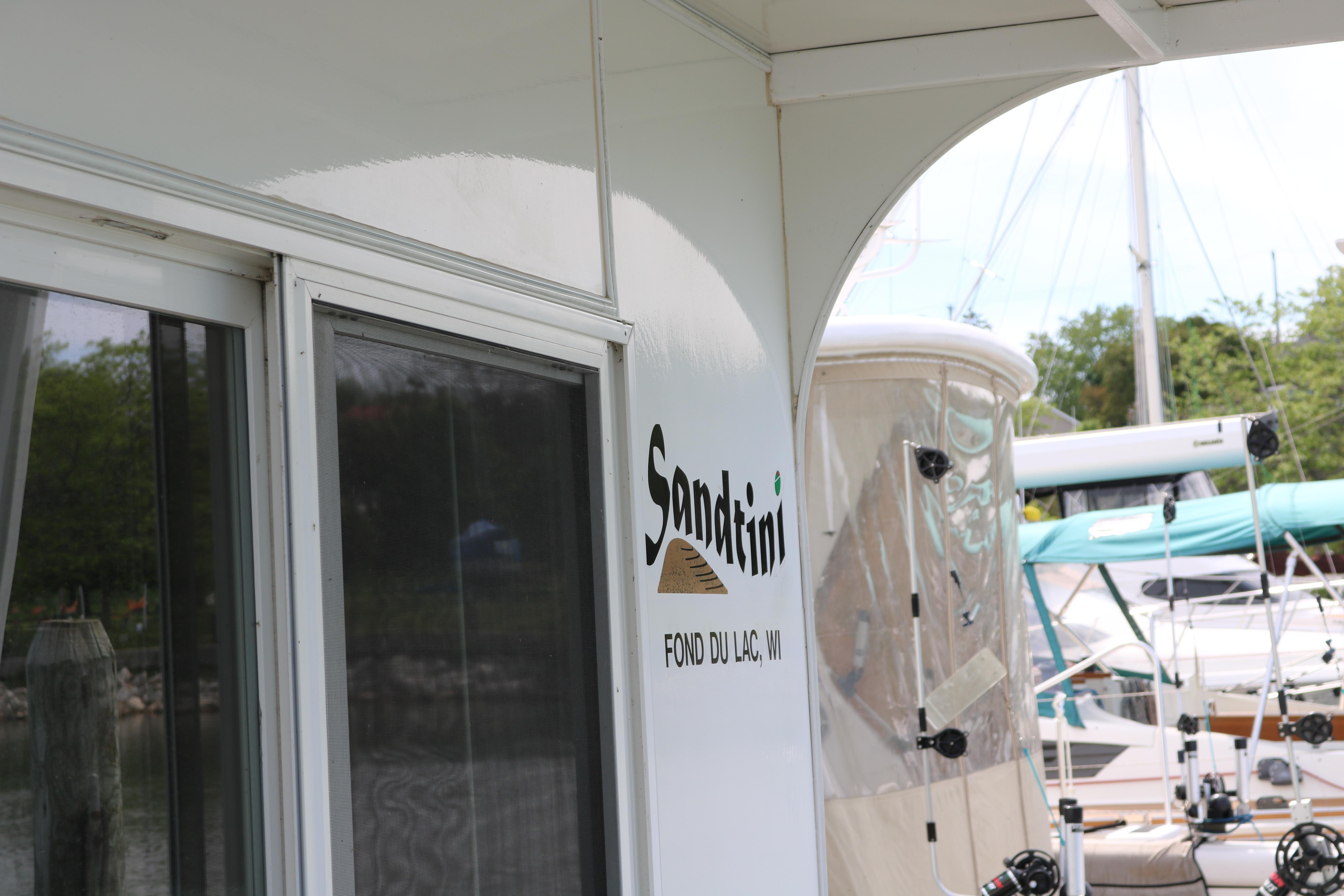 Skipperliner 480 Flybridge 2010 docked, featuring "Sandtini" signage, Fond du Lac, WI.
