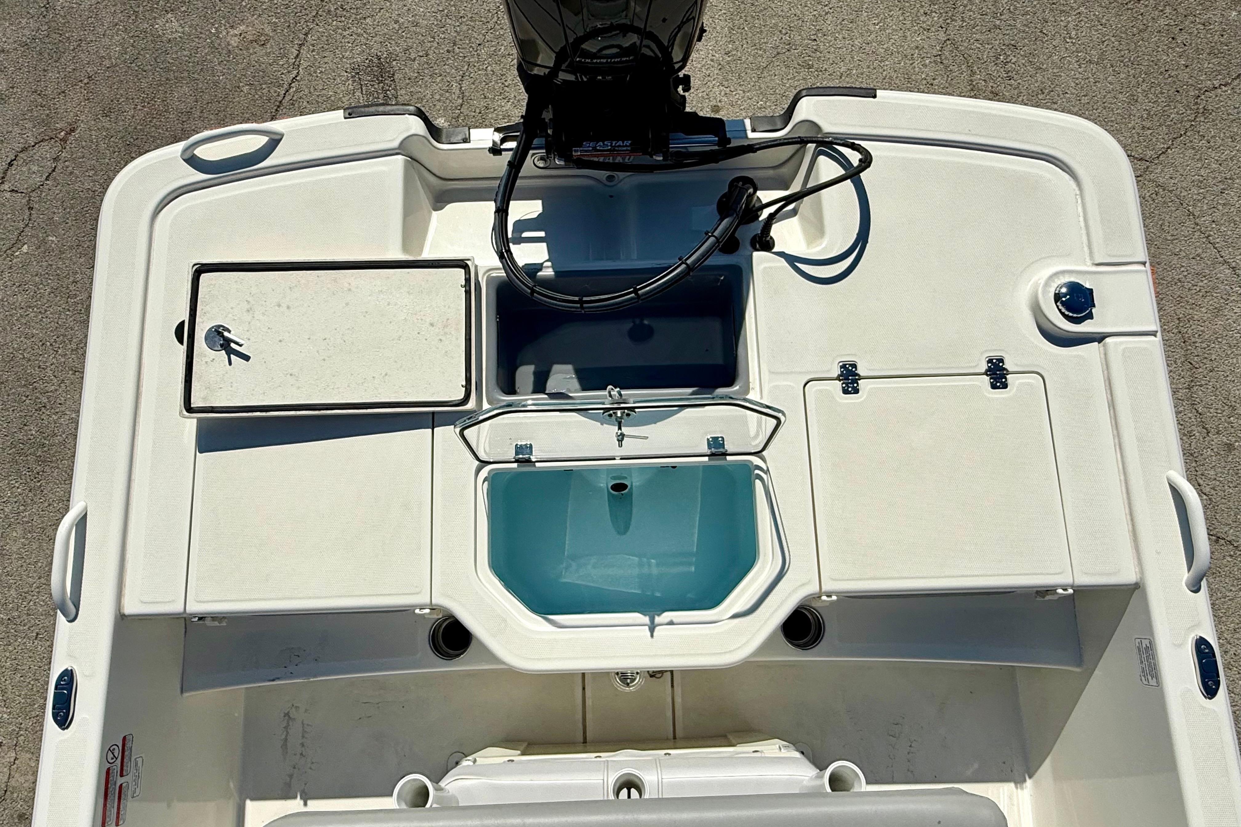 2024 Mako Pro Skiff 19 CC boat deck with storage compartments and livewell.