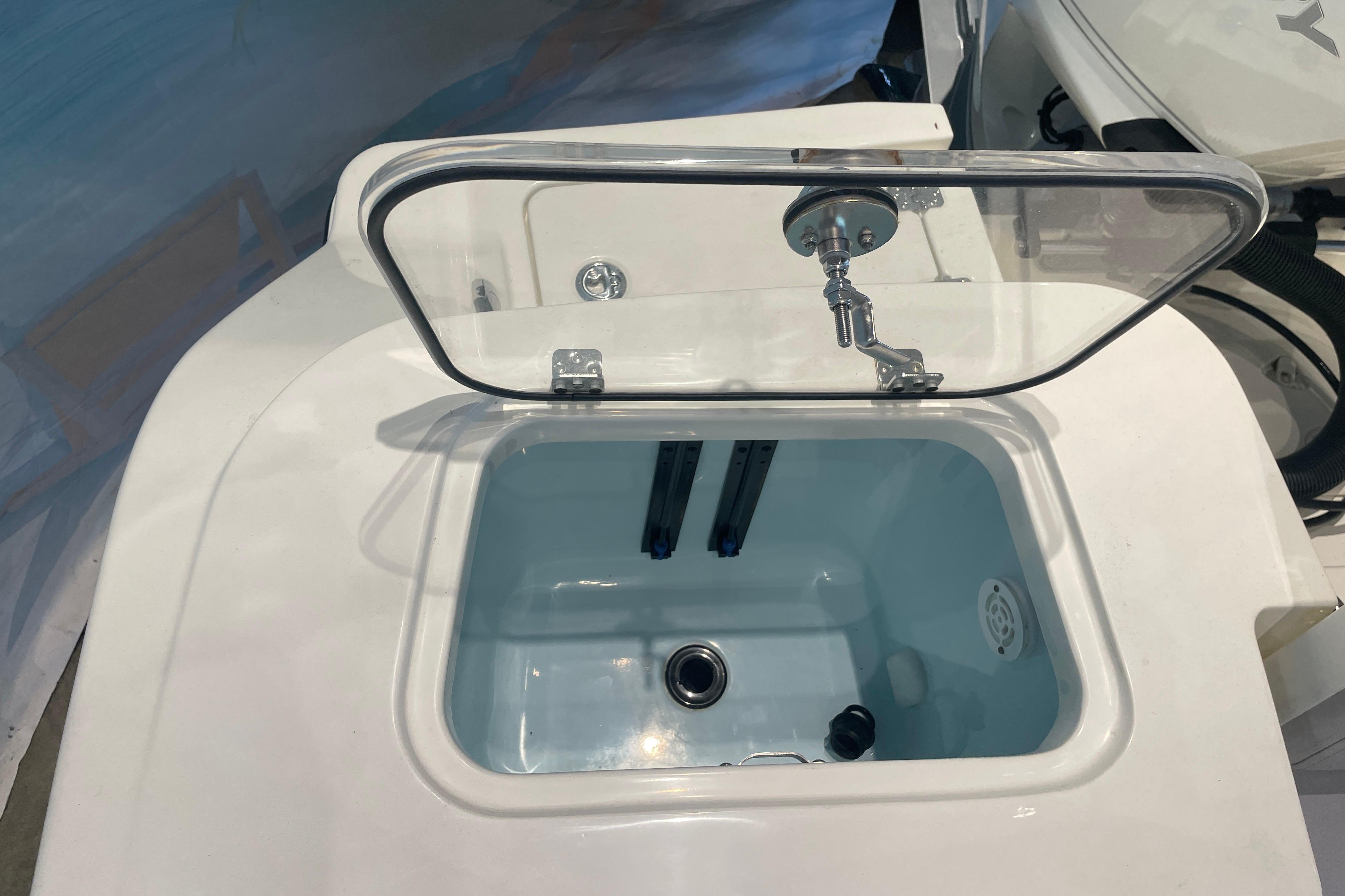 Livewell on 2026 Mako 226 Center Console boat, featuring a clear lid and faucet.