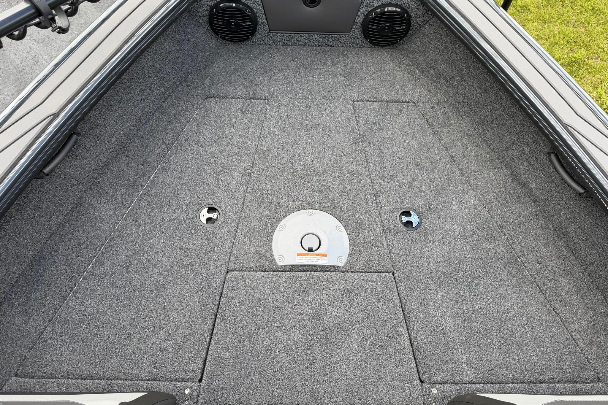 Interior view of 2027 Lund 1875 Crossover XS boat, featuring carpeted flooring and storage compartments.