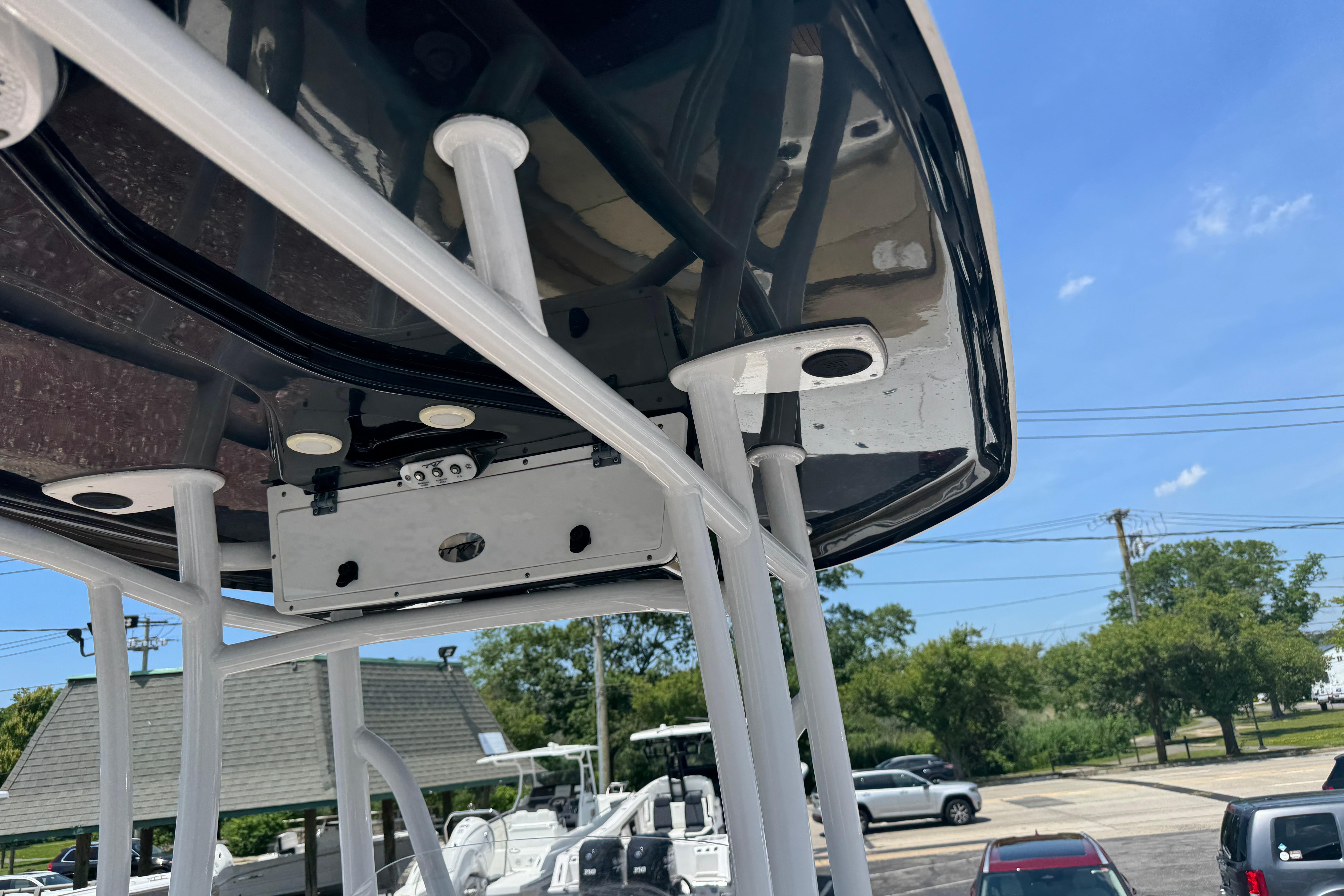 2016 Tidewater 230 LXF boat T-top structure under a clear blue sky.