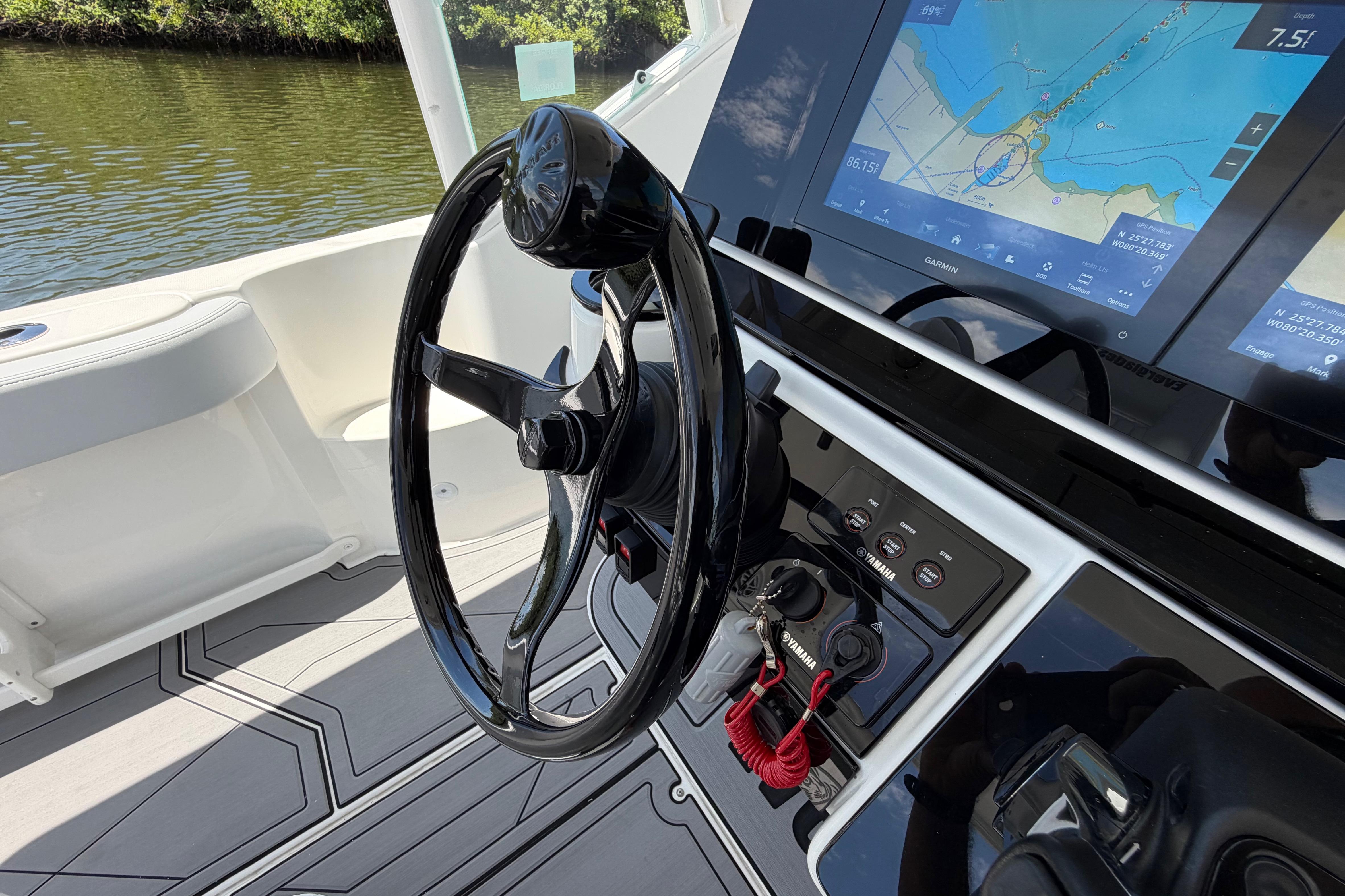 Steering wheel and navigation system of 2009 Everglades 350LX boat, featuring Garmin display.
