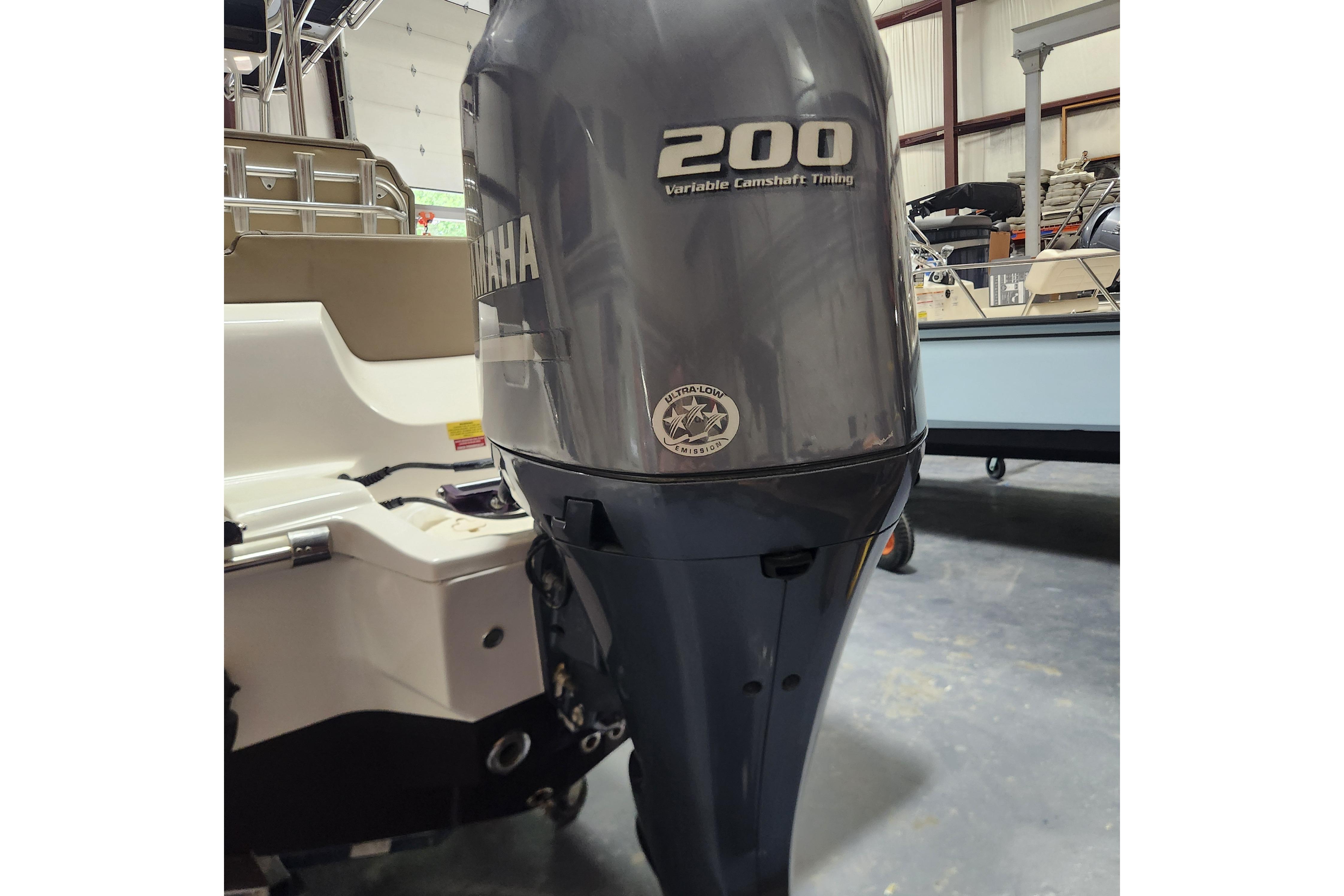 2023 Key West 219 FS boat with Yamaha 200 outboard motor in a showroom.