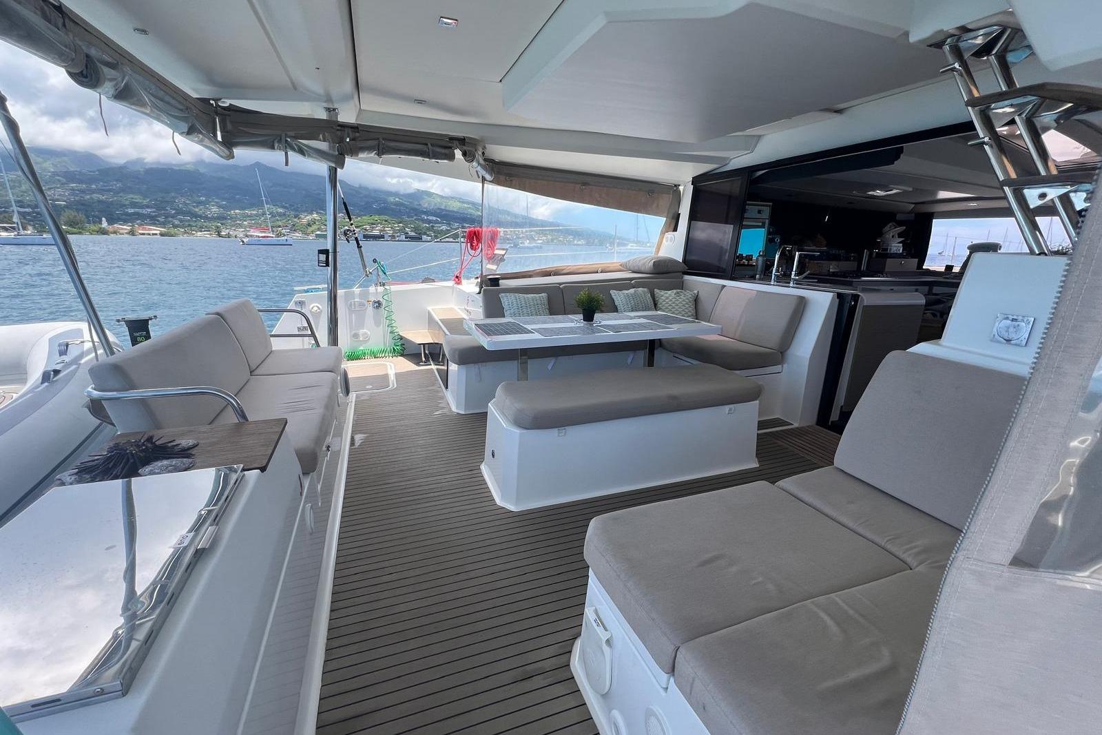 Luxurious 2022 Fountaine Pajot Elba 45 Catamaran interior with spacious seating and scenic ocean view.