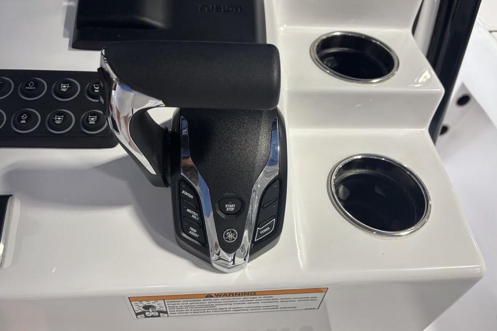 Throttle control and cup holders on 2026 Sportsman Masters 247 Bay Boat console.