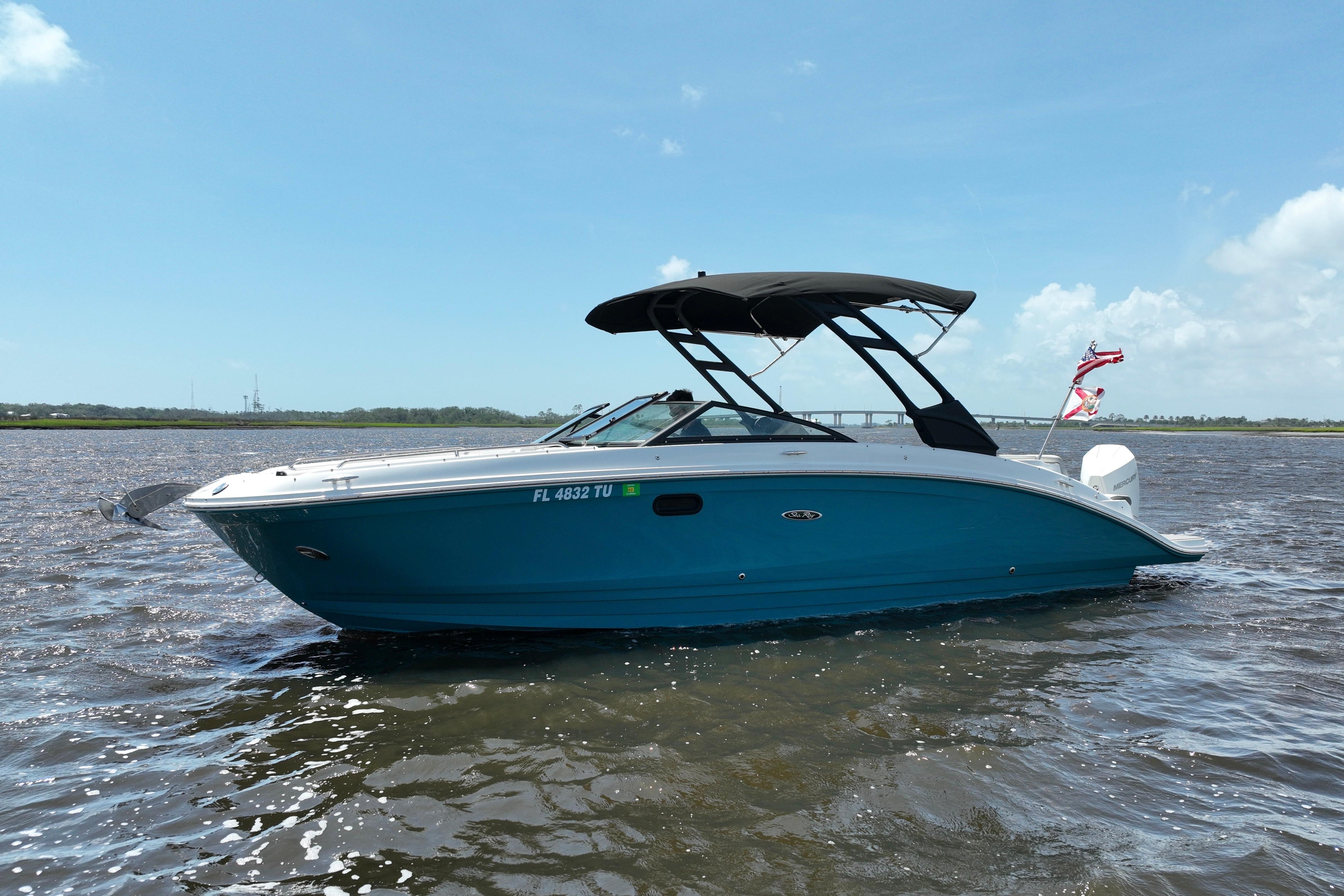 2024 Sea Ray SDX 270 Outboard boat on water, blue hull, black canopy.