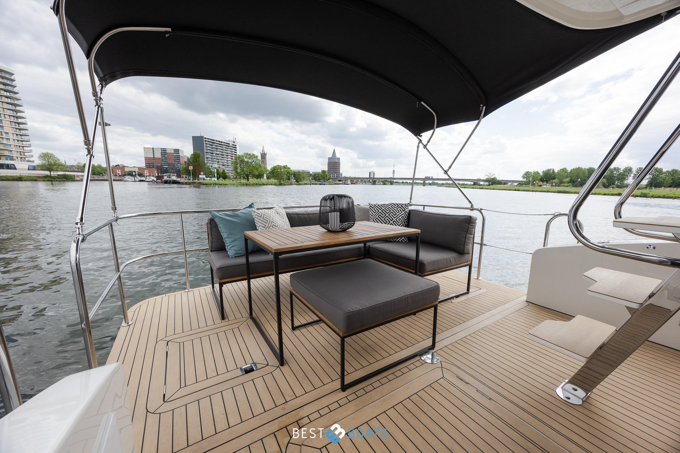 Luxurious 2023 Cobra Yachts Futura 36 Premium Fly deck with elegant seating and scenic river view.