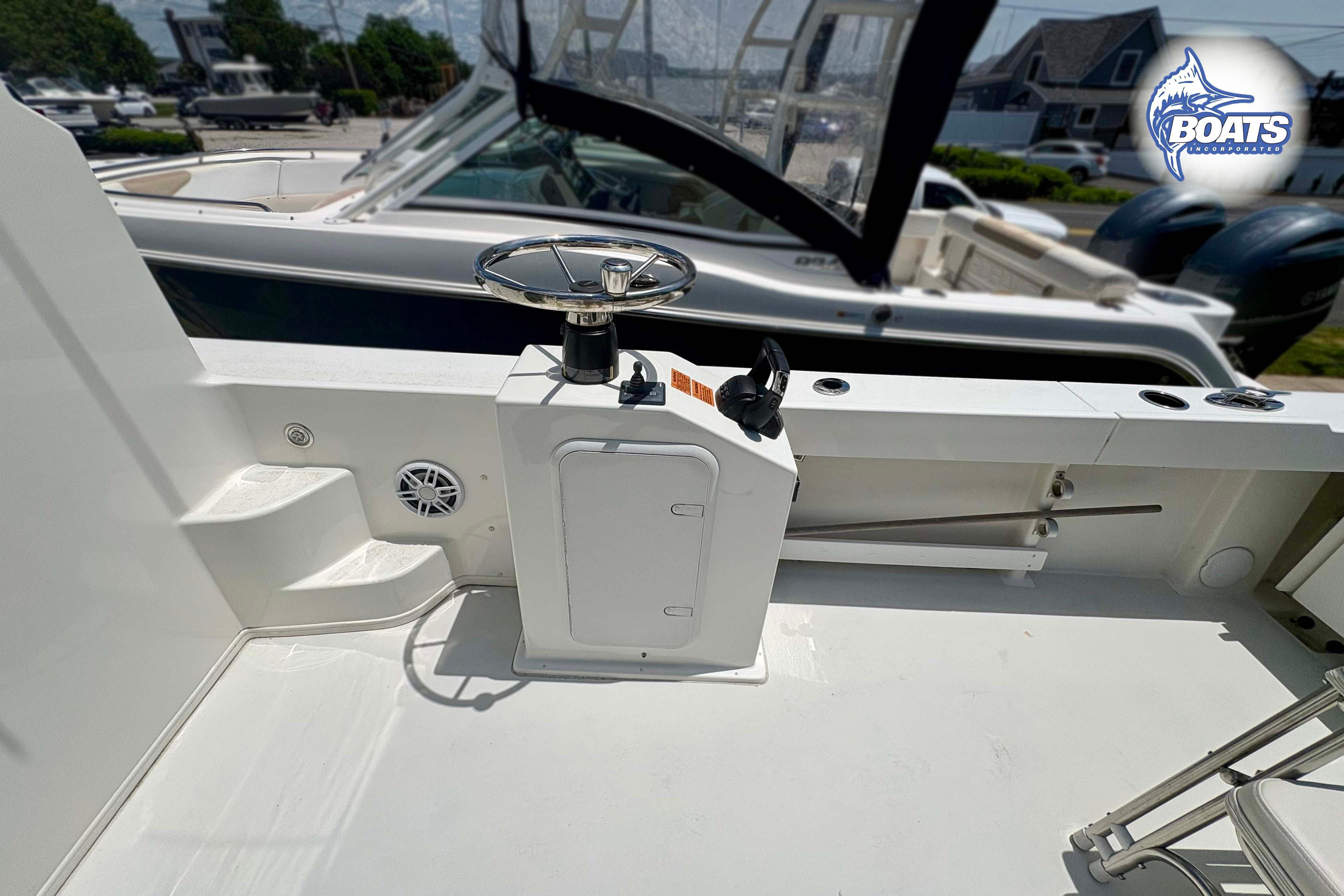 2021 Parker 2520 XLD Sport Cabin boat deck with steering wheel and control panel.