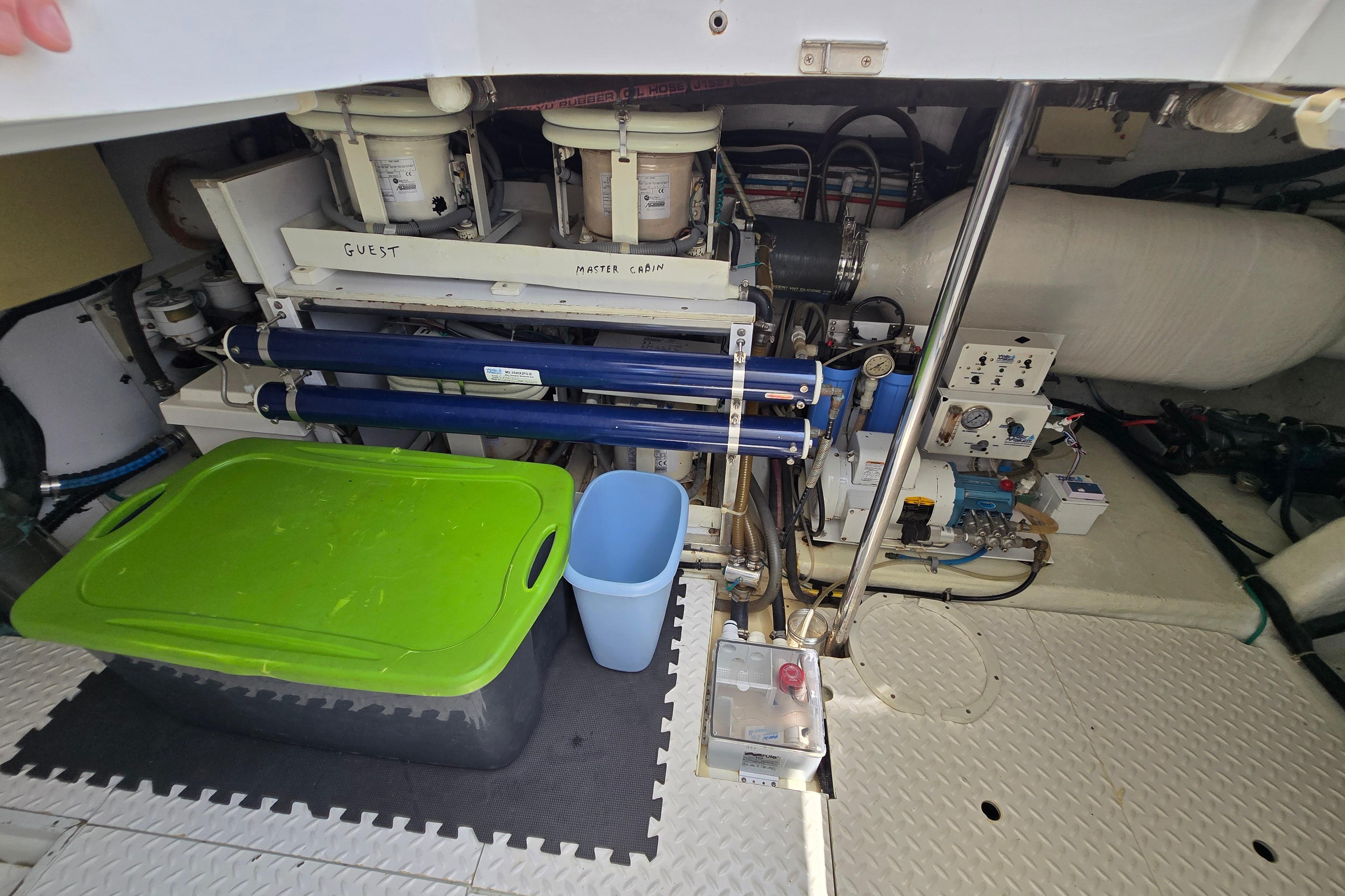 Engine room of 2004 Grand Harbour 58 yacht with equipment and storage containers.