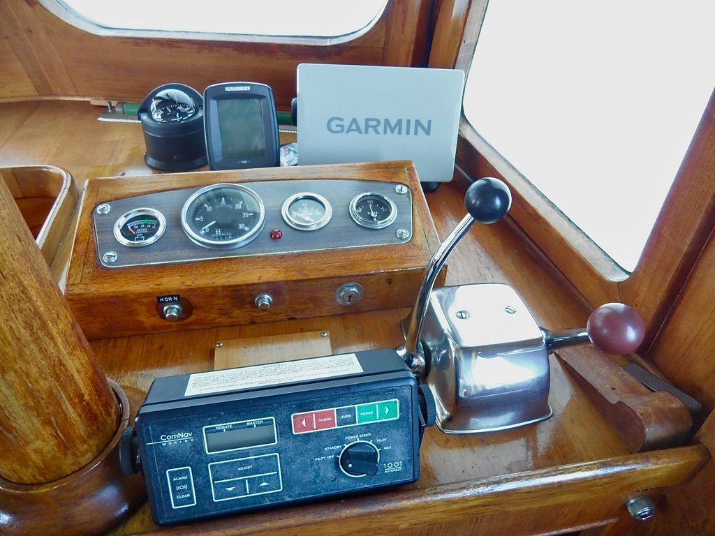 1976 CHB Trawler helm with Garmin GPS, gauges, and controls.