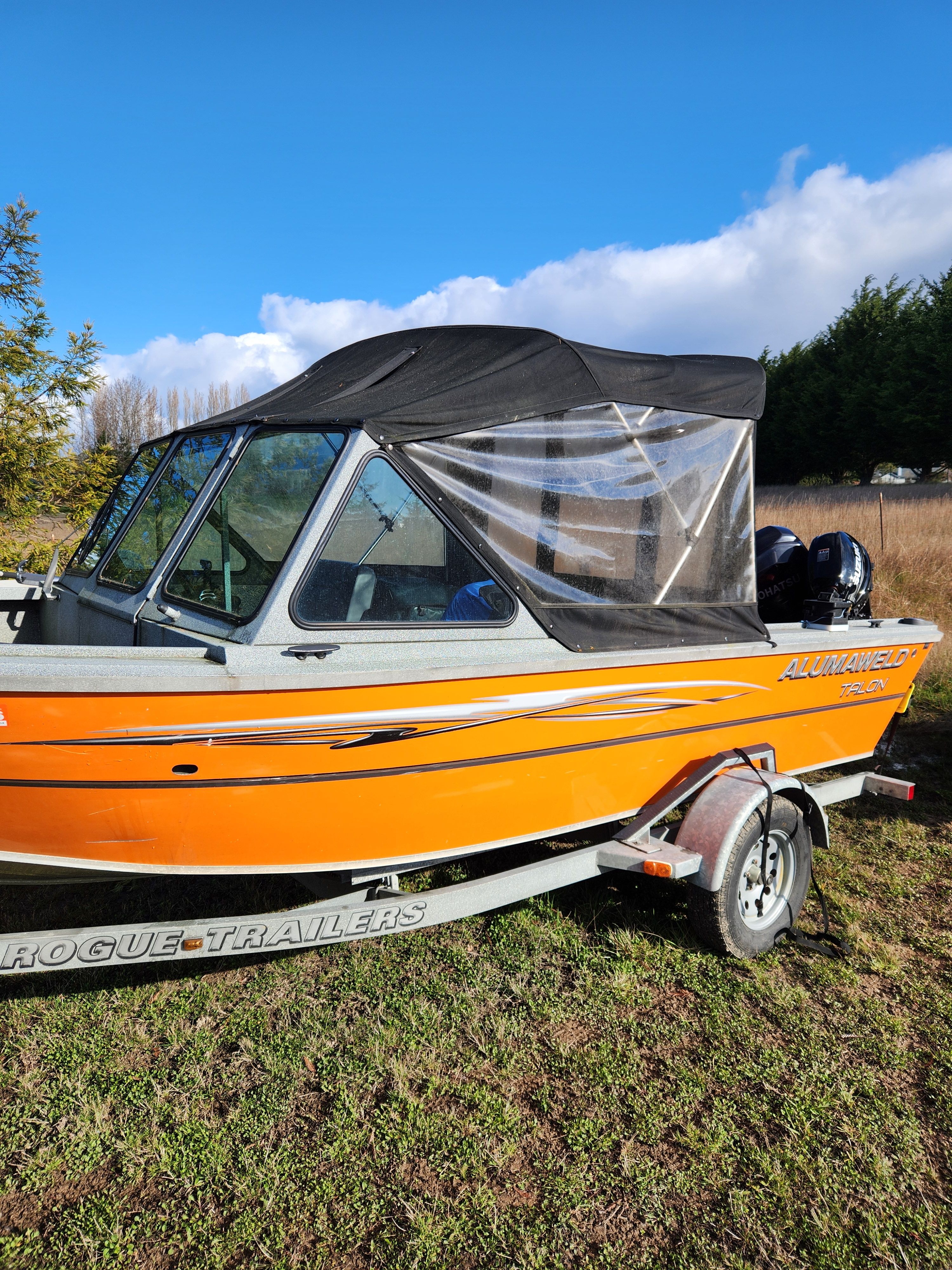 2020 Alumaweld Talon 18 boat on trailer outdoors.
