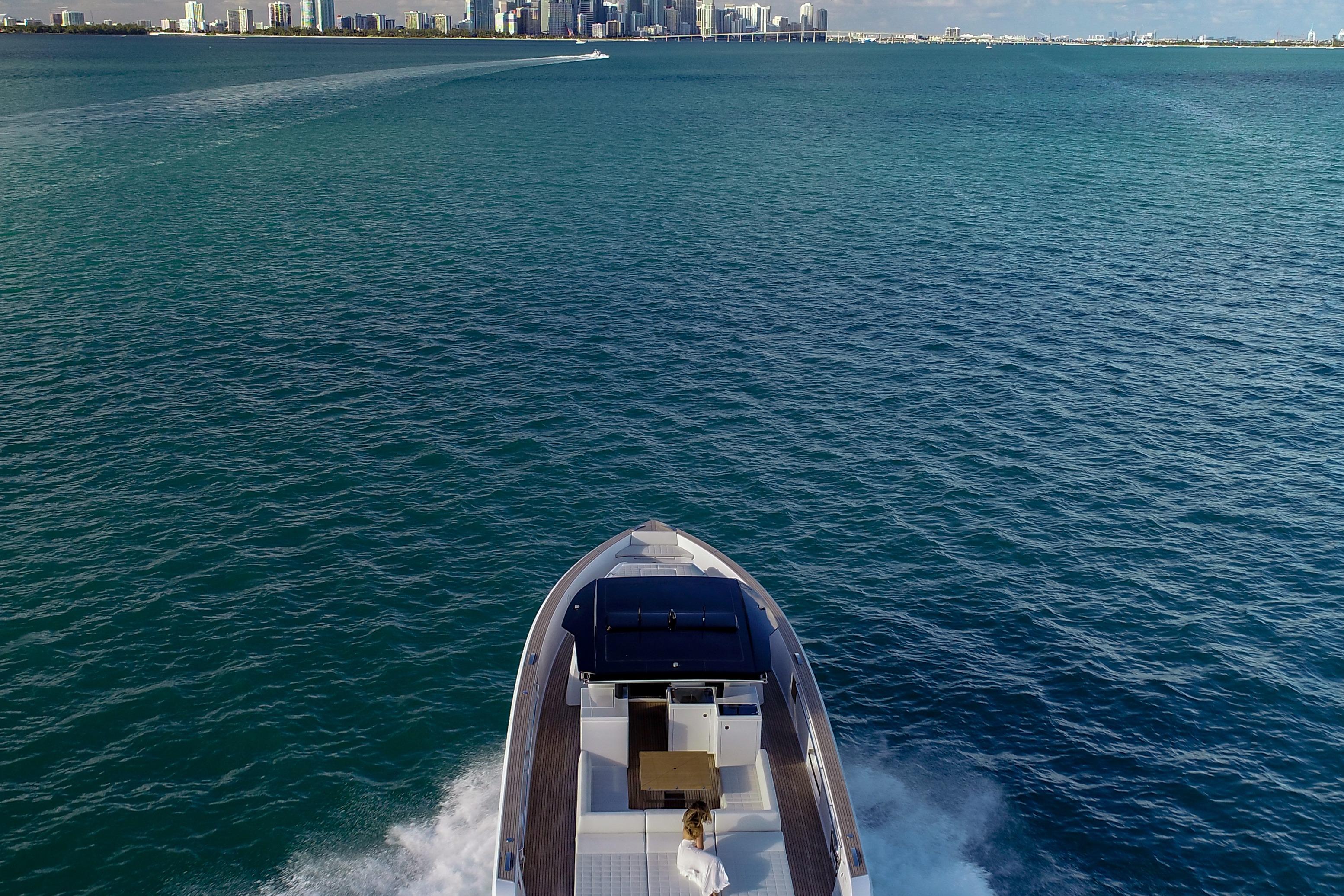 2025 Pardo Yachts 50 cruising on open water with city skyline in background.