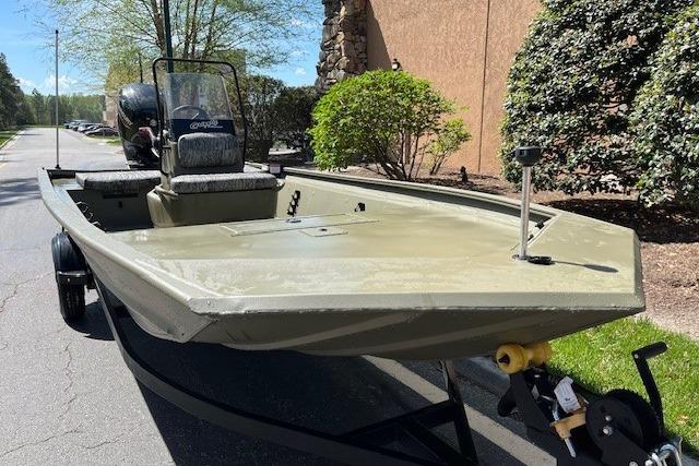 2026 Tracker Grizzly 1860 CC boat on trailer, parked outdoors.