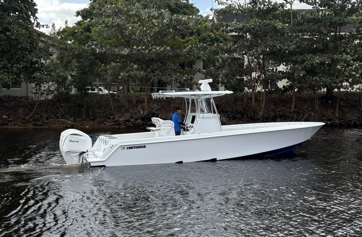 2025 Contender 32 ST boat on calm water.