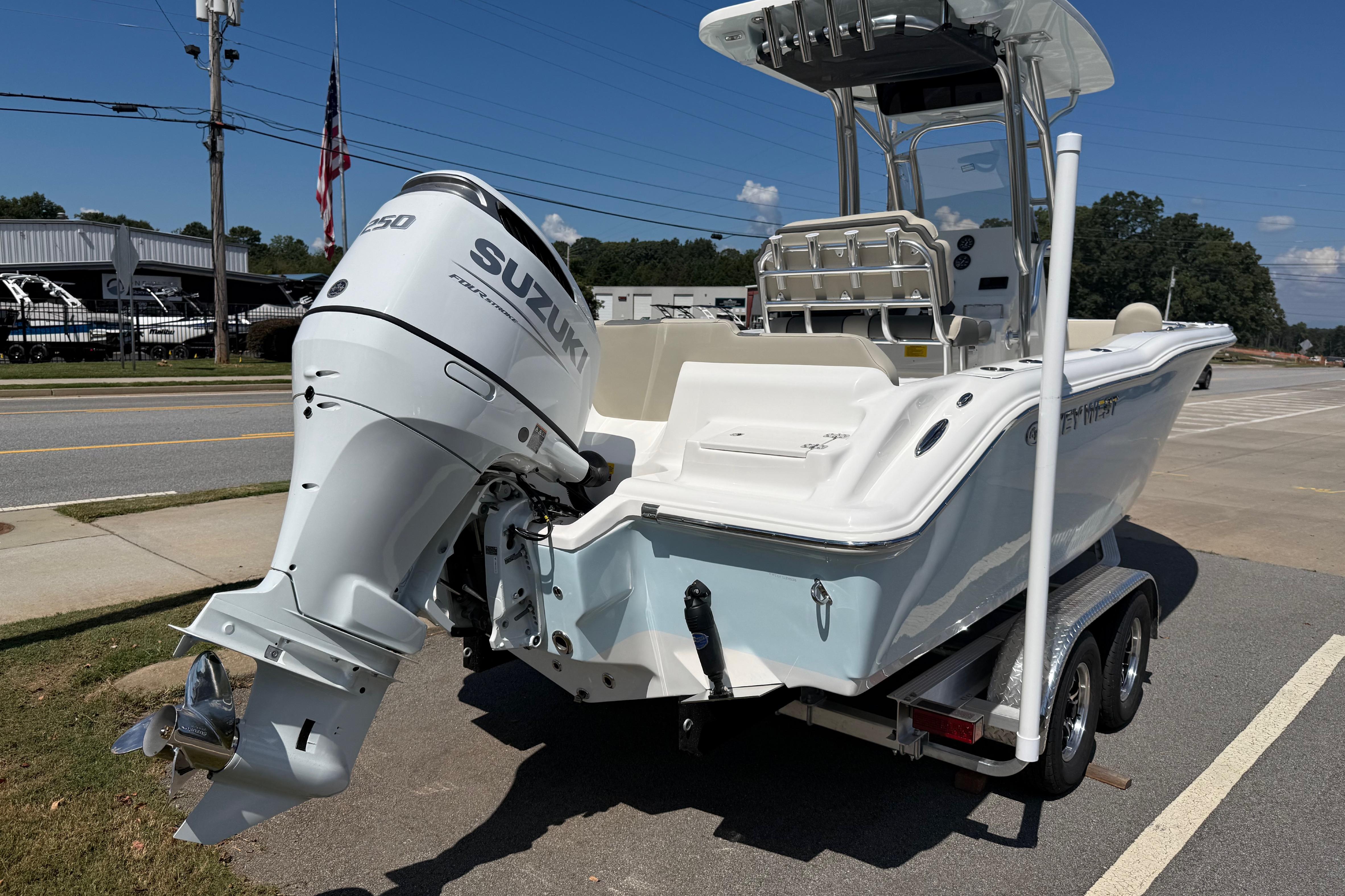 2026 Key West 239 FS boat with Suzuki engine on trailer, parked roadside.