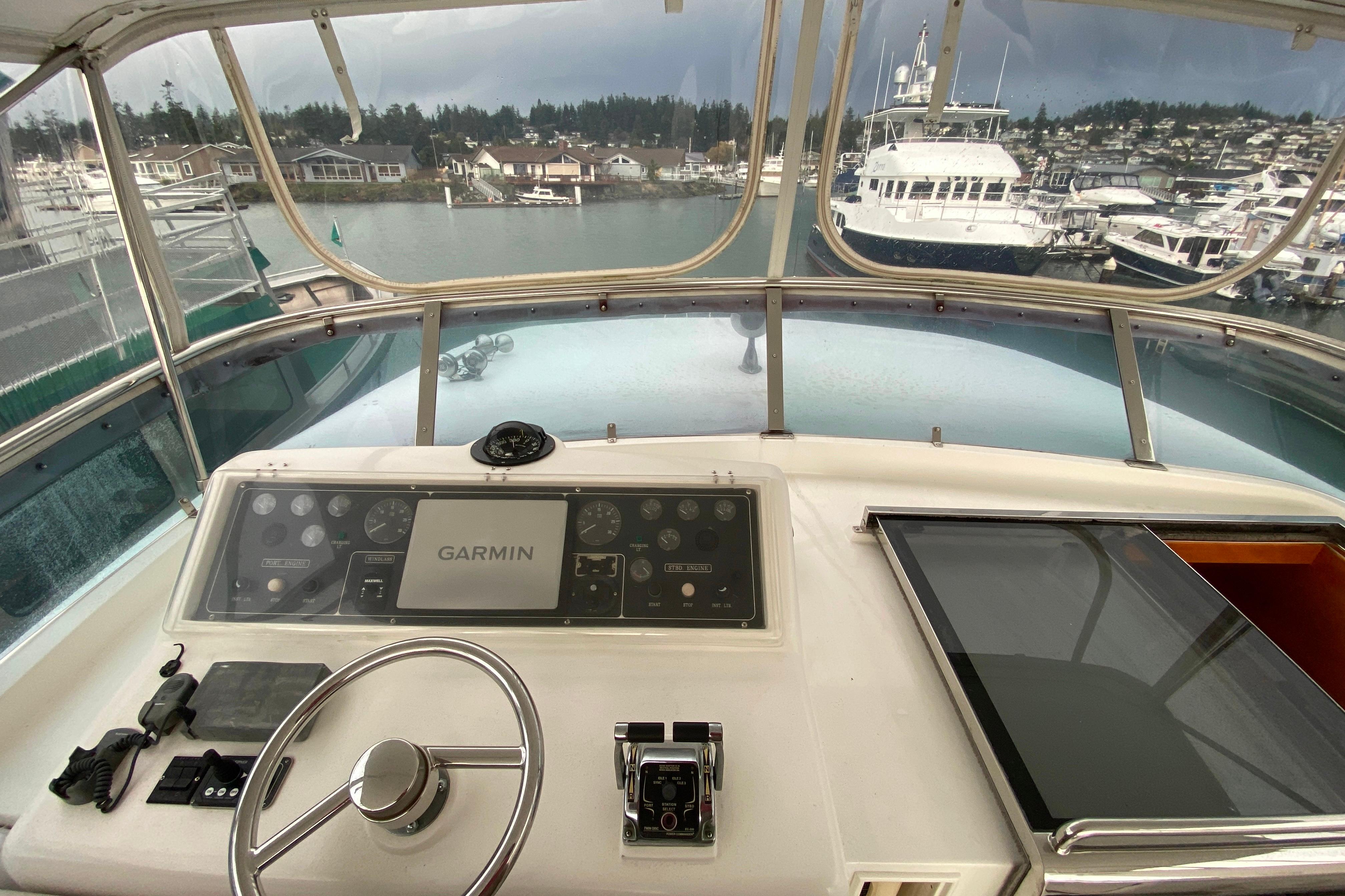 Cockpit view of 2001 Compass 57 yacht with Garmin navigation system at marina.