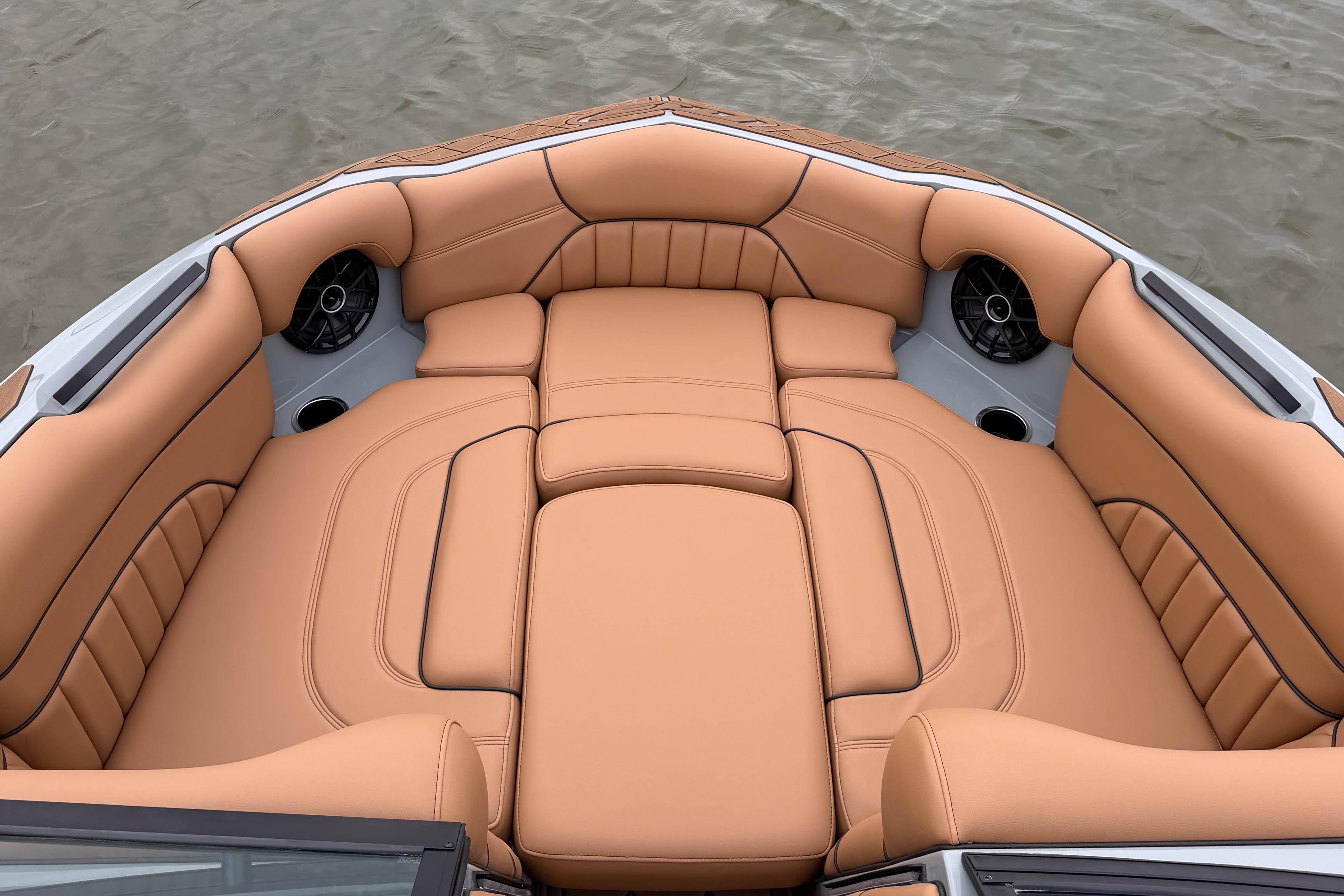 Luxurious tan seating on 2026 MB B52 21 Alpha boat, featuring built-in speakers.