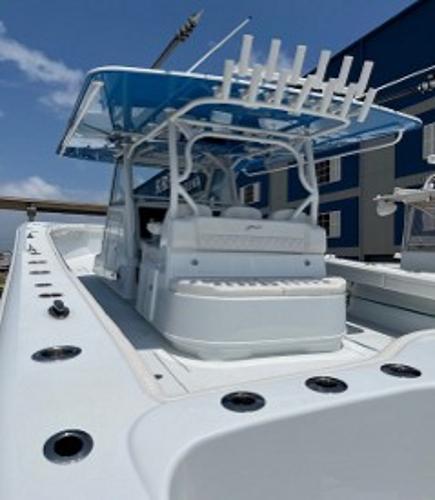 2022 Yellowfin 39 Offshore boat with blue canopy and fishing rod holders.