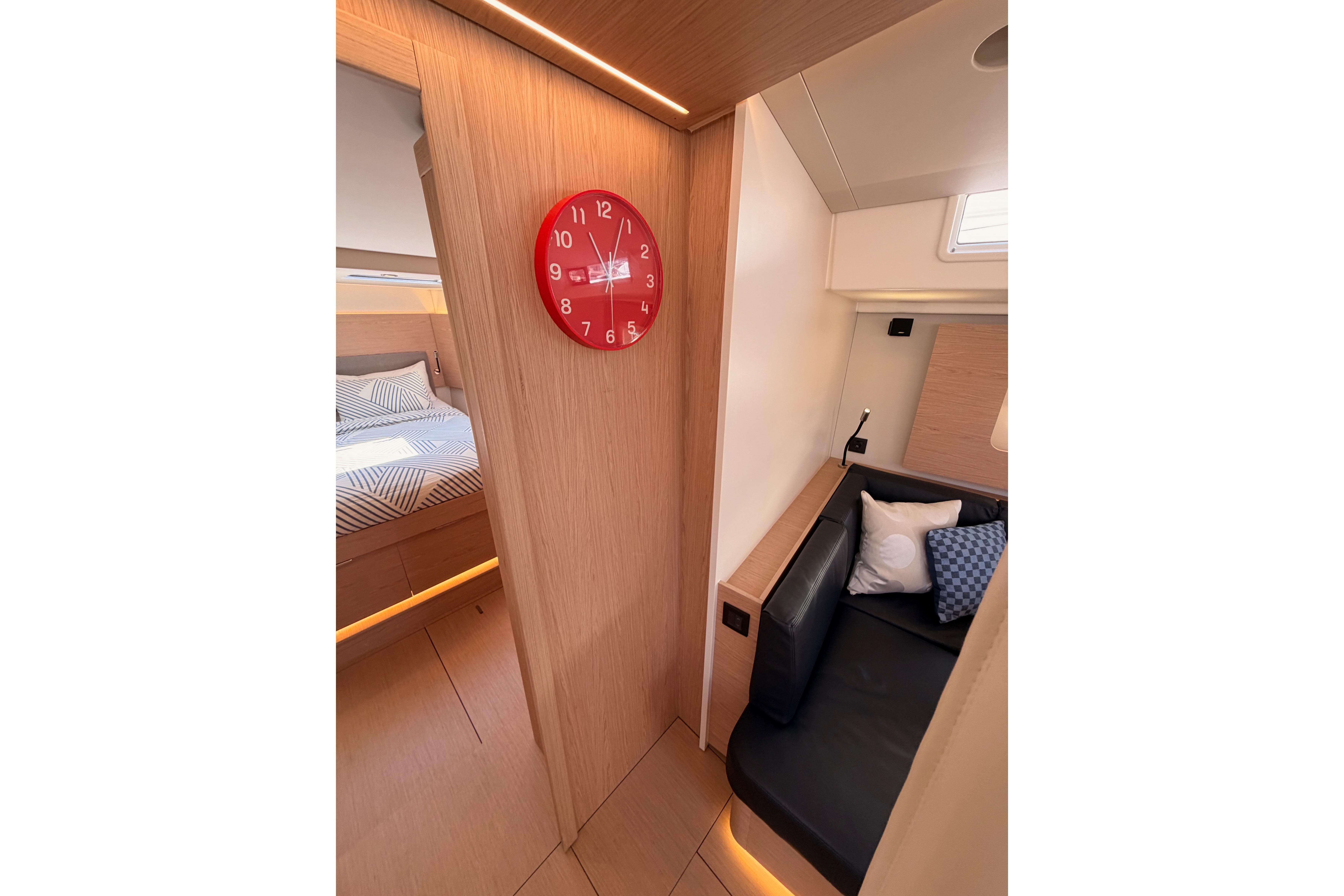 Interior of 2022 Beneteau Oceanis Yacht 54, featuring cozy seating and modern design elements.