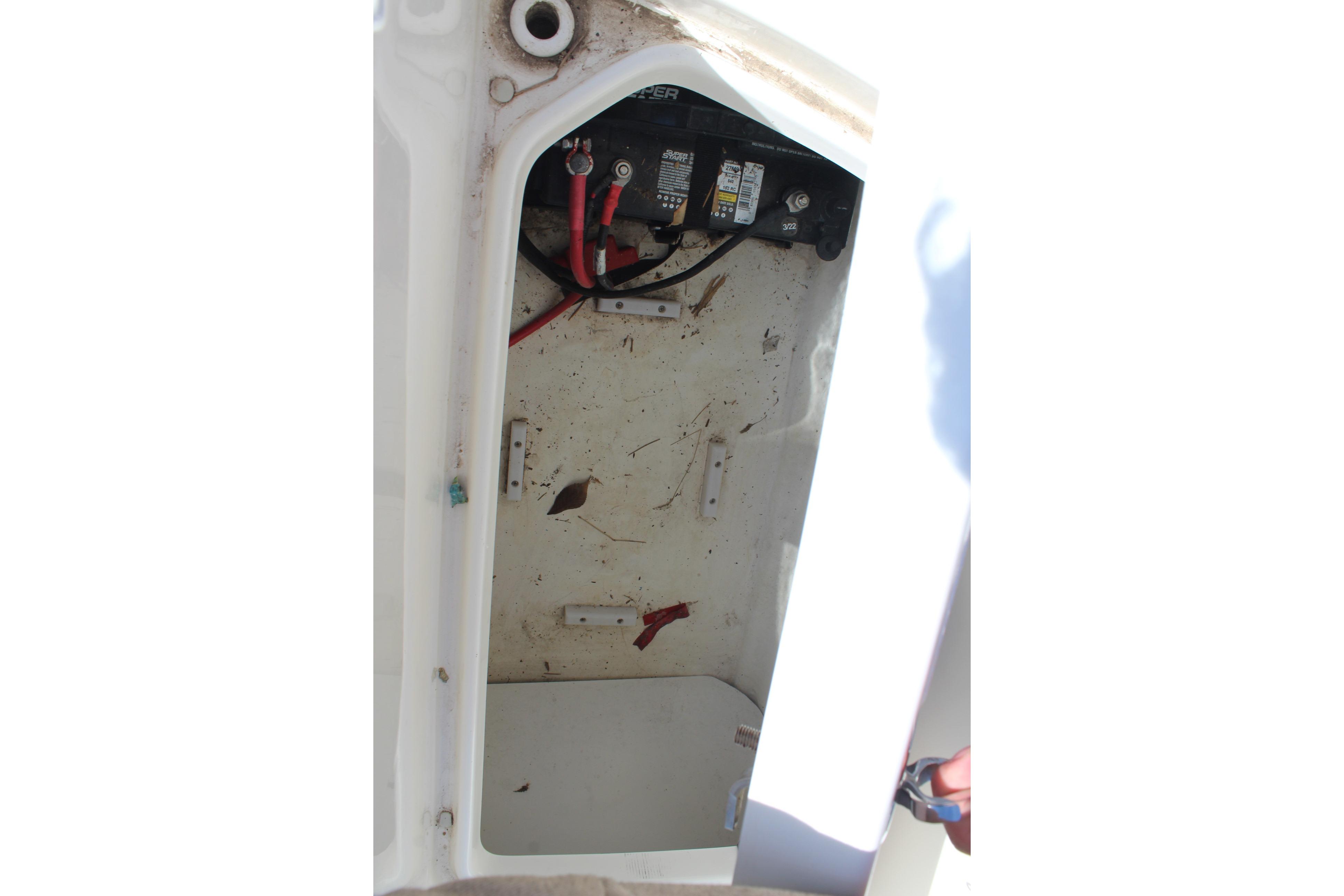 Battery compartment of a 2015 Sea Ray 19 SPX OB boat, showing wiring and connections.
