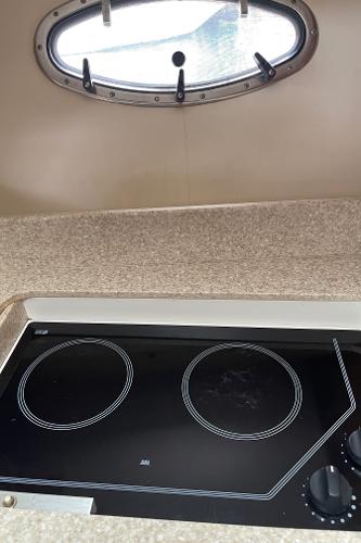 2003 Tiara Yachts 3500 Open kitchen with electric stove and porthole window.