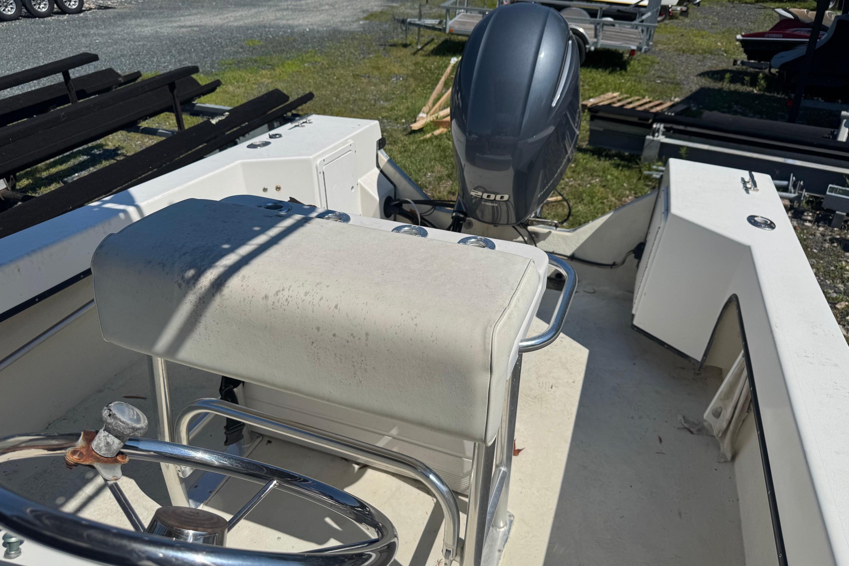 1997 Maycraft 23 boat interior with steering wheel and outboard motor.