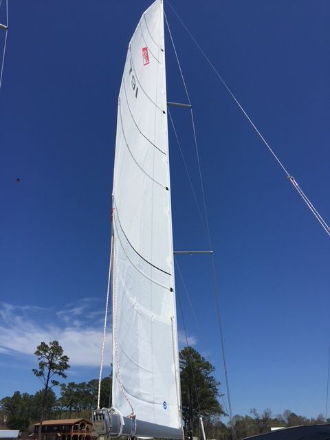 2001 Catalina 320 sailboat with raised sail against blue sky.