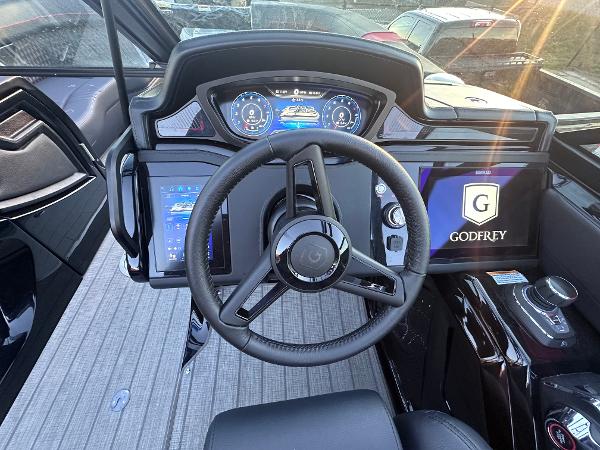 Godfrey XP 2700 W 2025 boat dashboard with advanced digital displays and steering wheel.