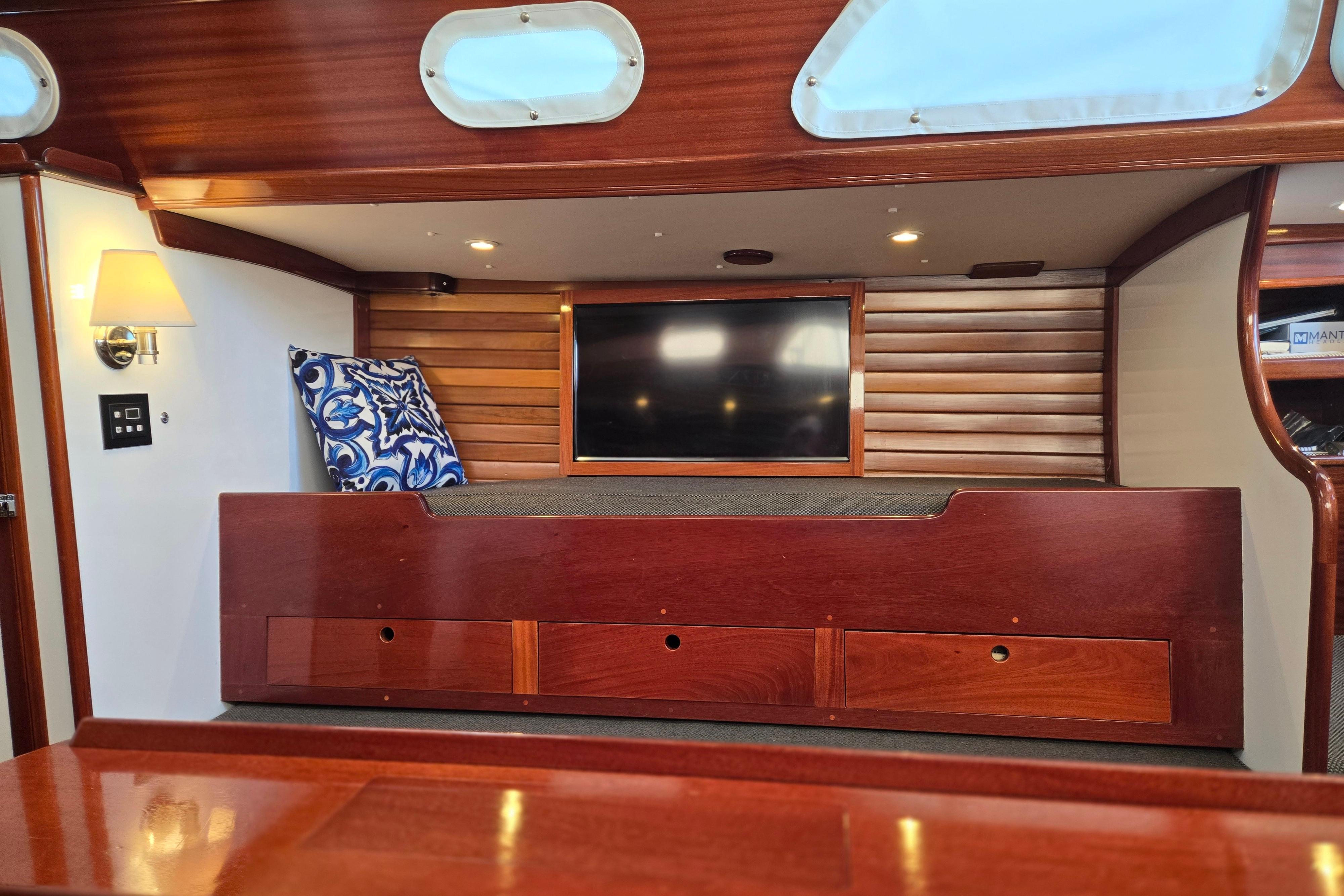 Interior of a 1970 Hinckley Bermuda 40 yacht with wooden finish and cozy seating.
