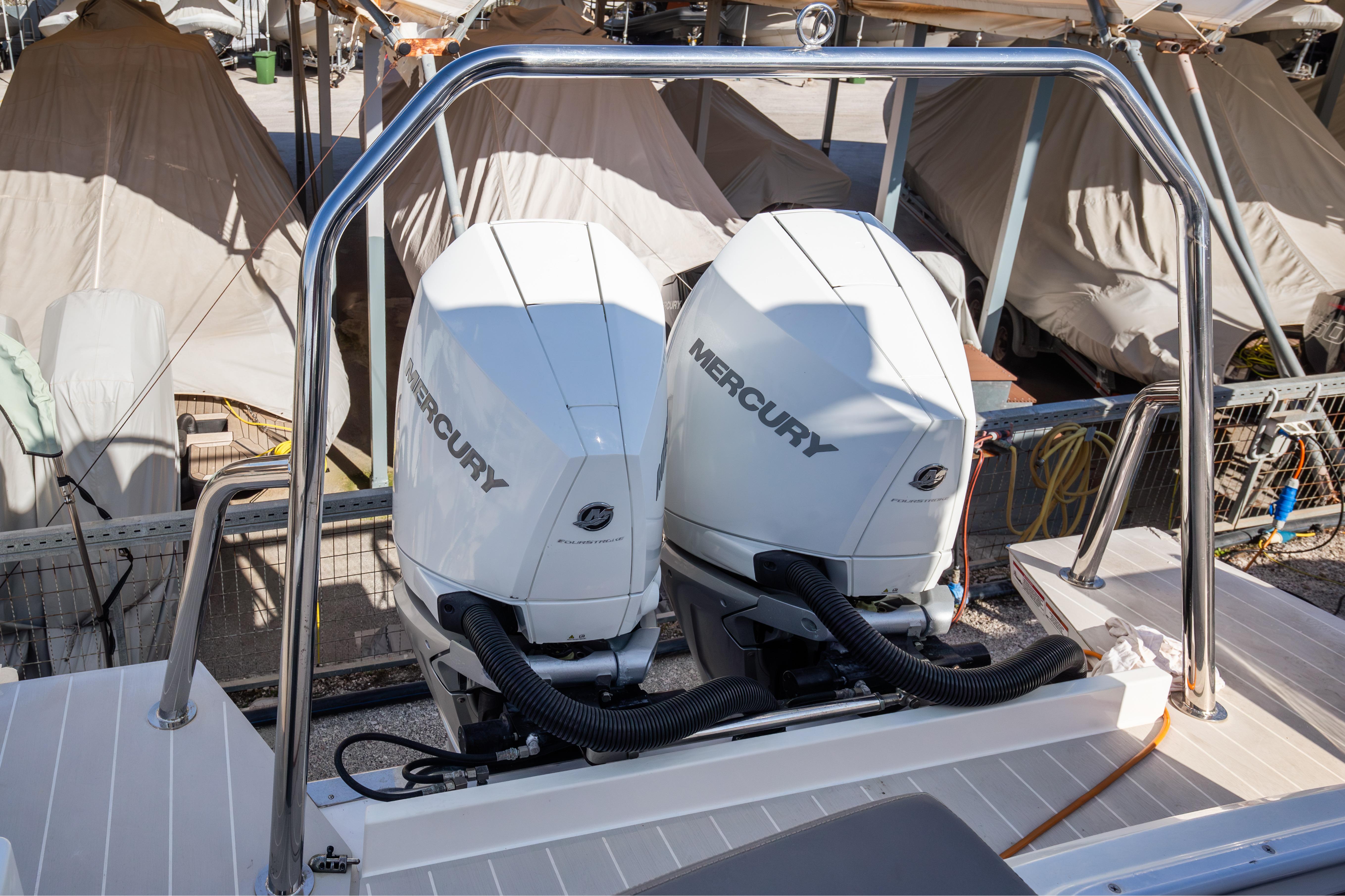2018 Axopar 37 Sun-Top with dual Mercury outboard engines, docked in a marina.