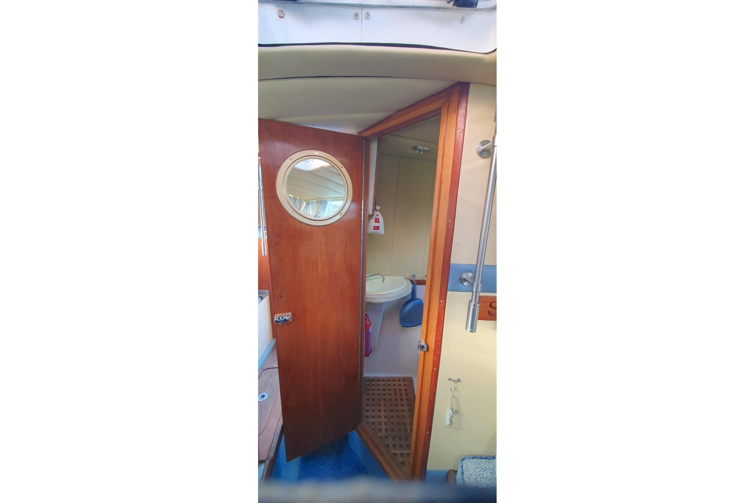 Interior of 1989 Fairey Spearfish MKIII boat with wooden door and porthole.
