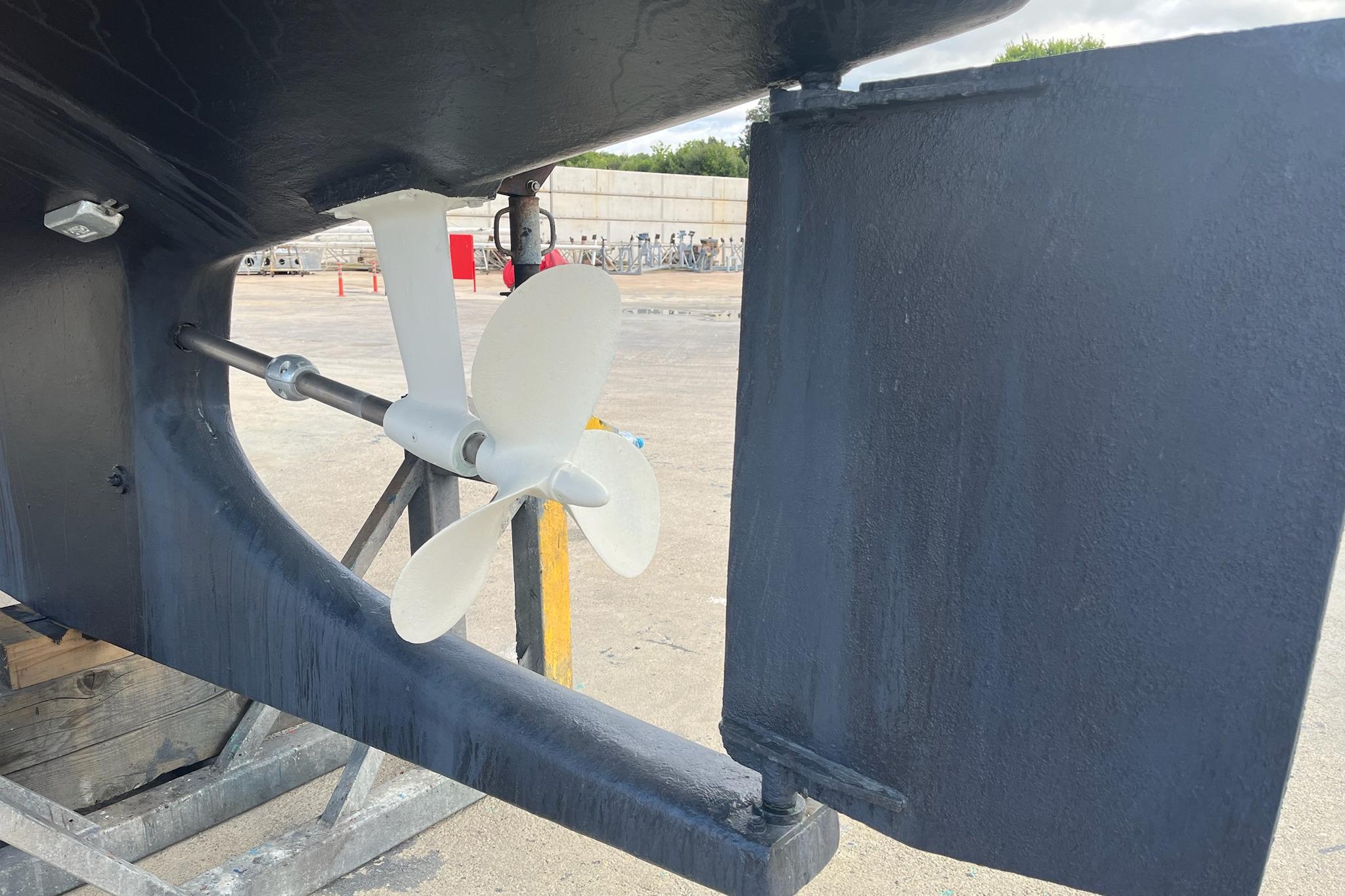 Propeller and rudder of a 1977 Siltala Nauticat 33 sailboat on dry dock.