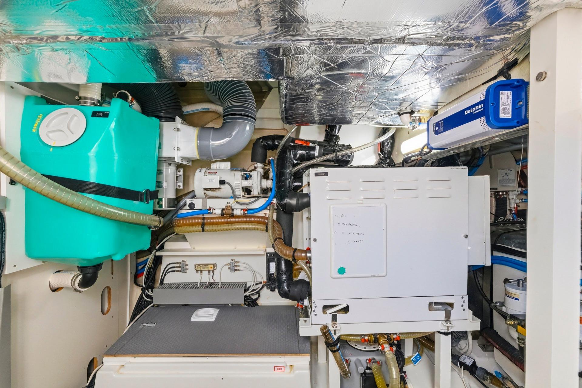 Engine room of a 2022 Prestige 520 yacht with various mechanical components.