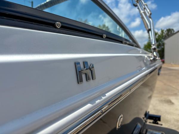 2023 Four Winns H1 boat side view with logo, showcasing sleek design.