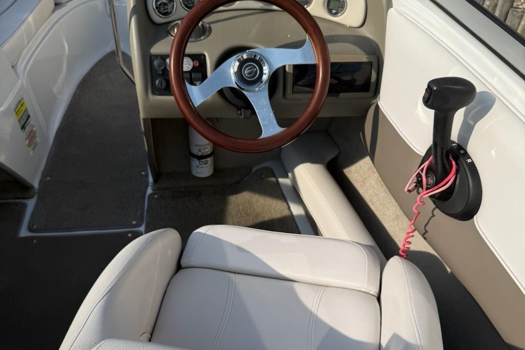 Interior of a 2012 195 SS boat with steering wheel and controls.