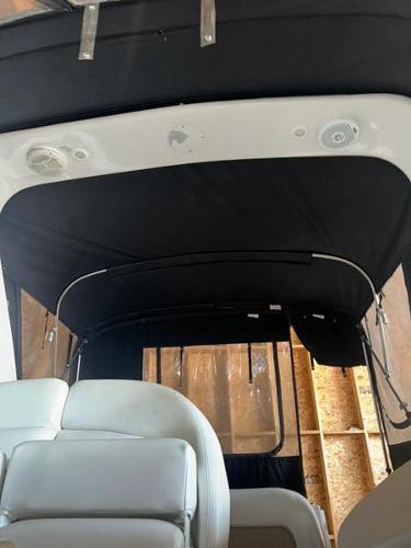 2005 Four Winns 298 Vista boat interior with black canopy and white seating.