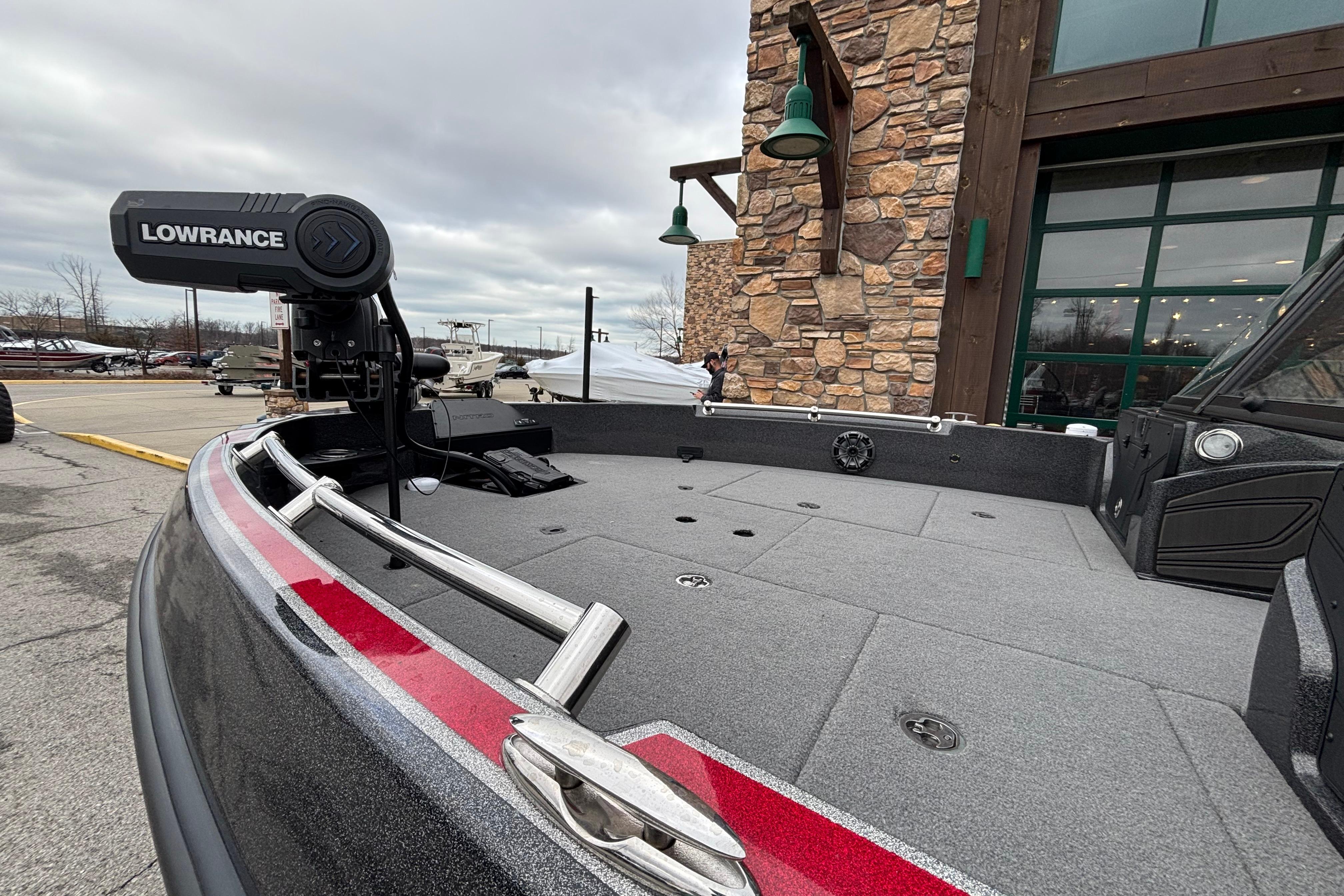 2024 Nitro ZV21 Pro boat with Lowrance equipment, docked near a stone building.