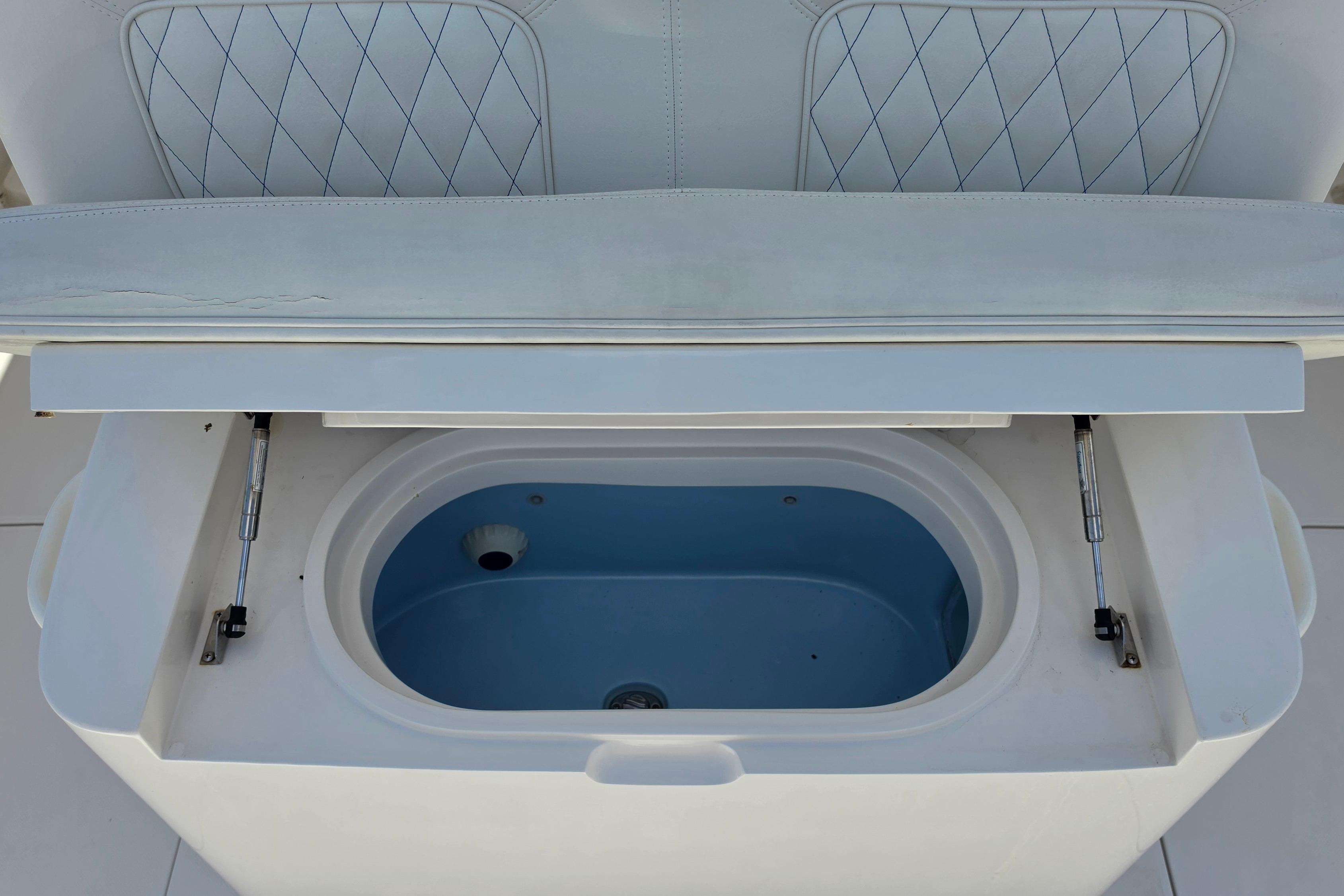 Open storage compartment on a 2020 Jupiter 34 HFS boat, featuring a blue interior.