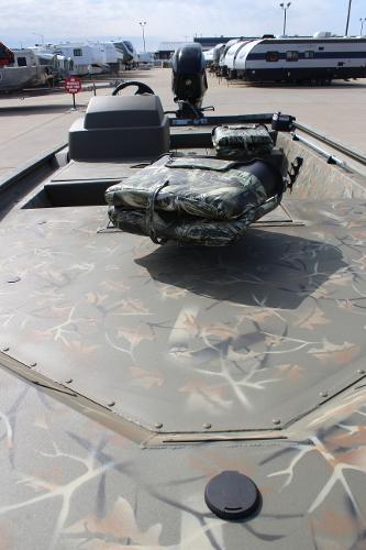 2024 Tracker Grizzly 1754 SC boat with camo pattern, parked in a lot.