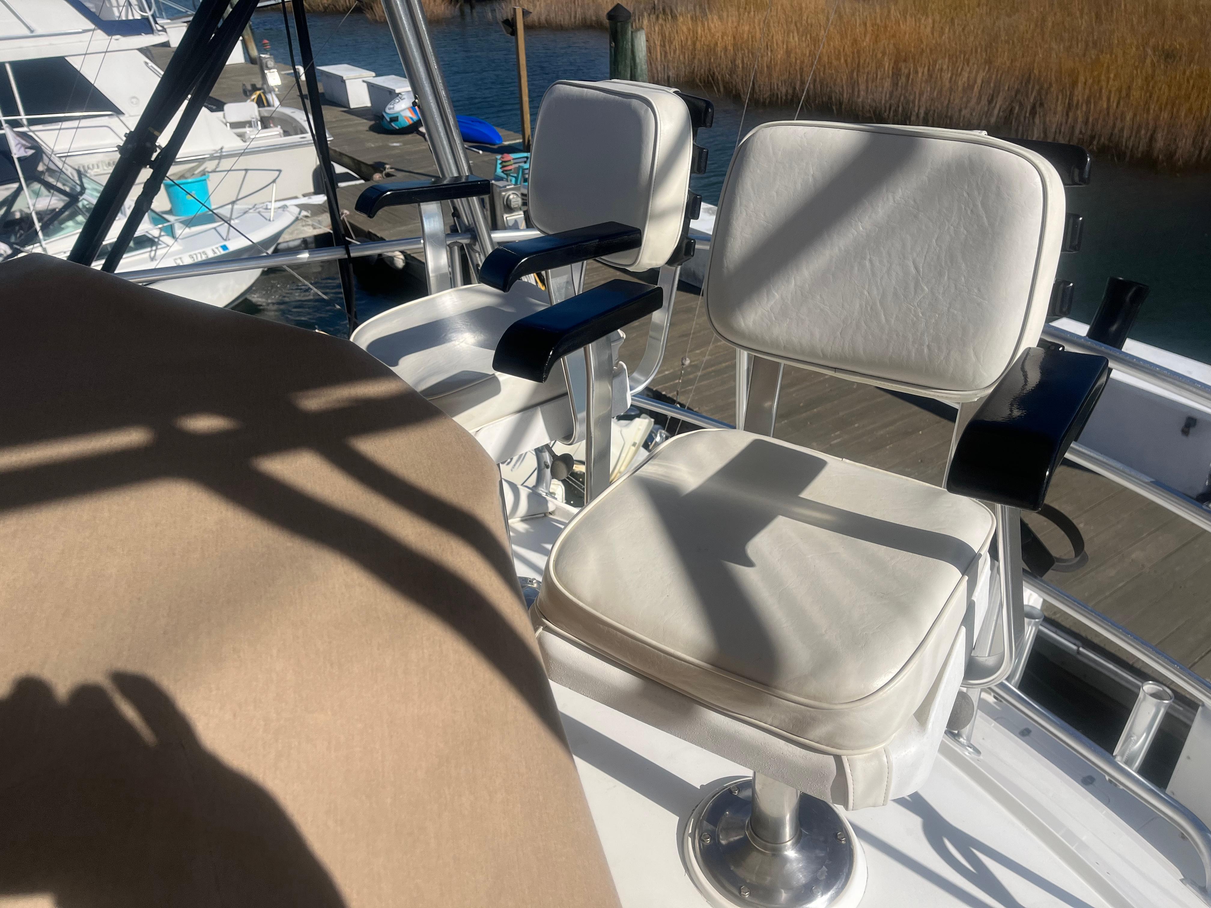1993 Bertram 37 Convertible boat with white cushioned seats on deck.