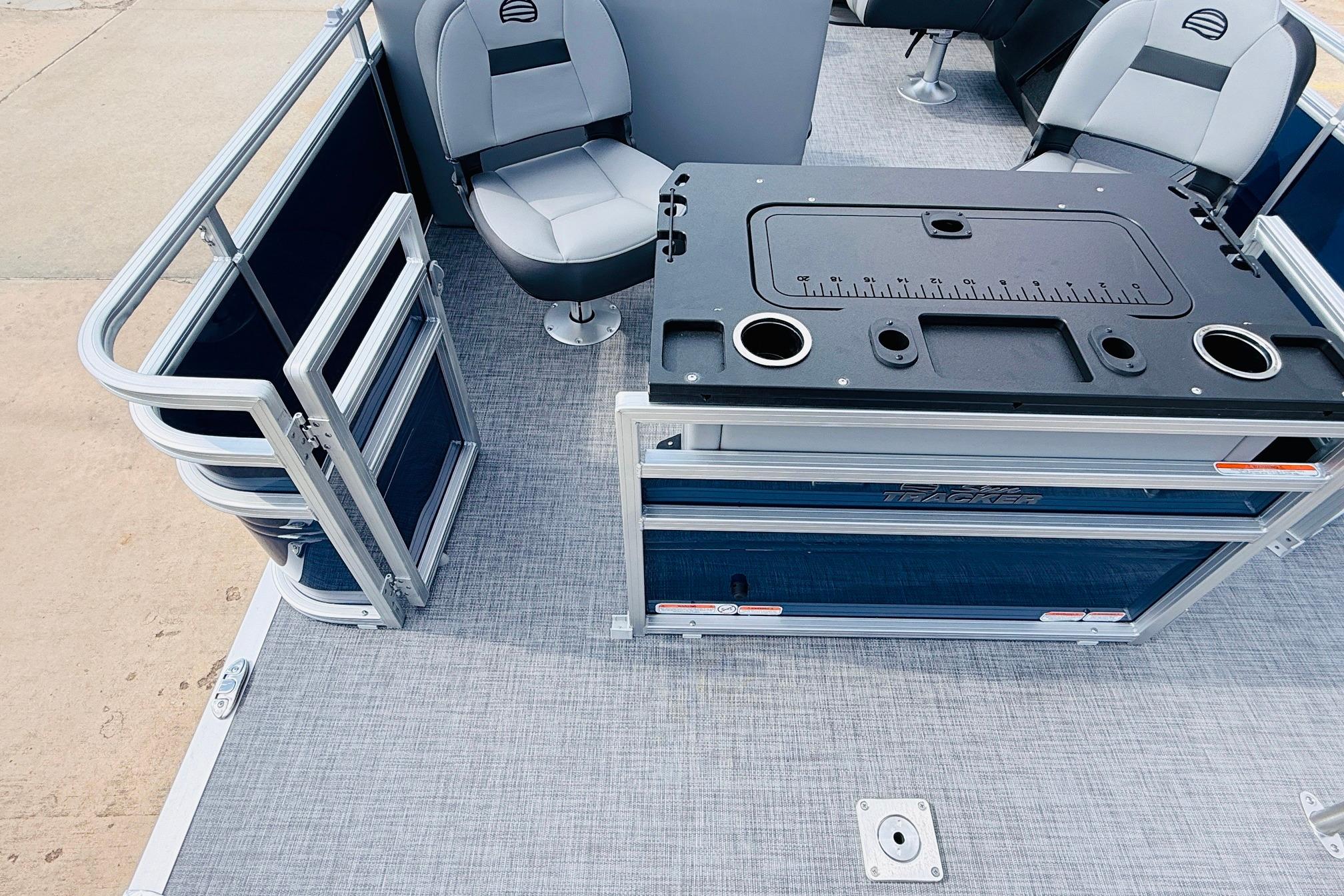 2026 Sun Tracker SportFish 22 DLX pontoon boat interior with seating and fishing station.