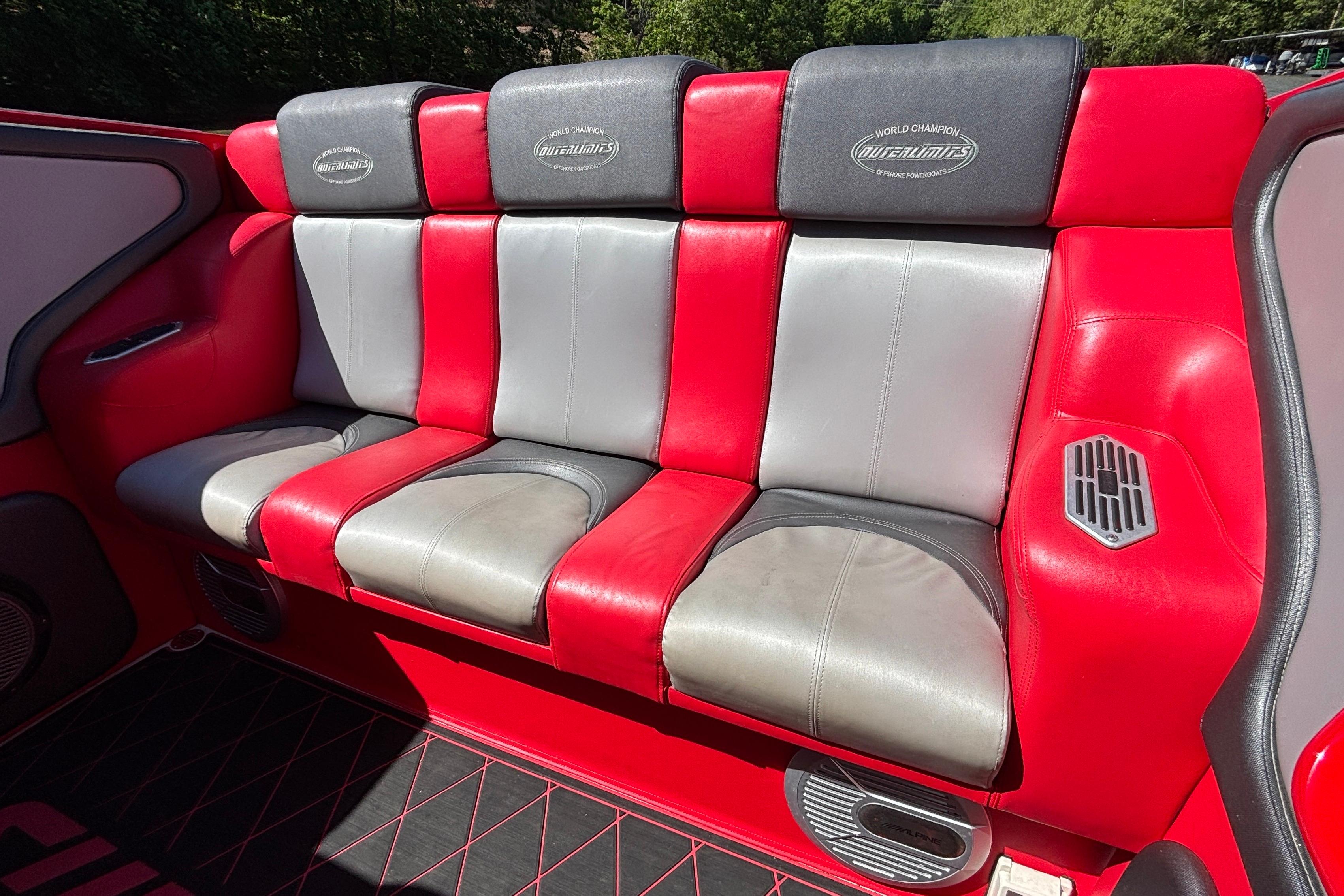 Red and gray leather seating in a 2004 Outerlimits 42 Legacy boat interior.