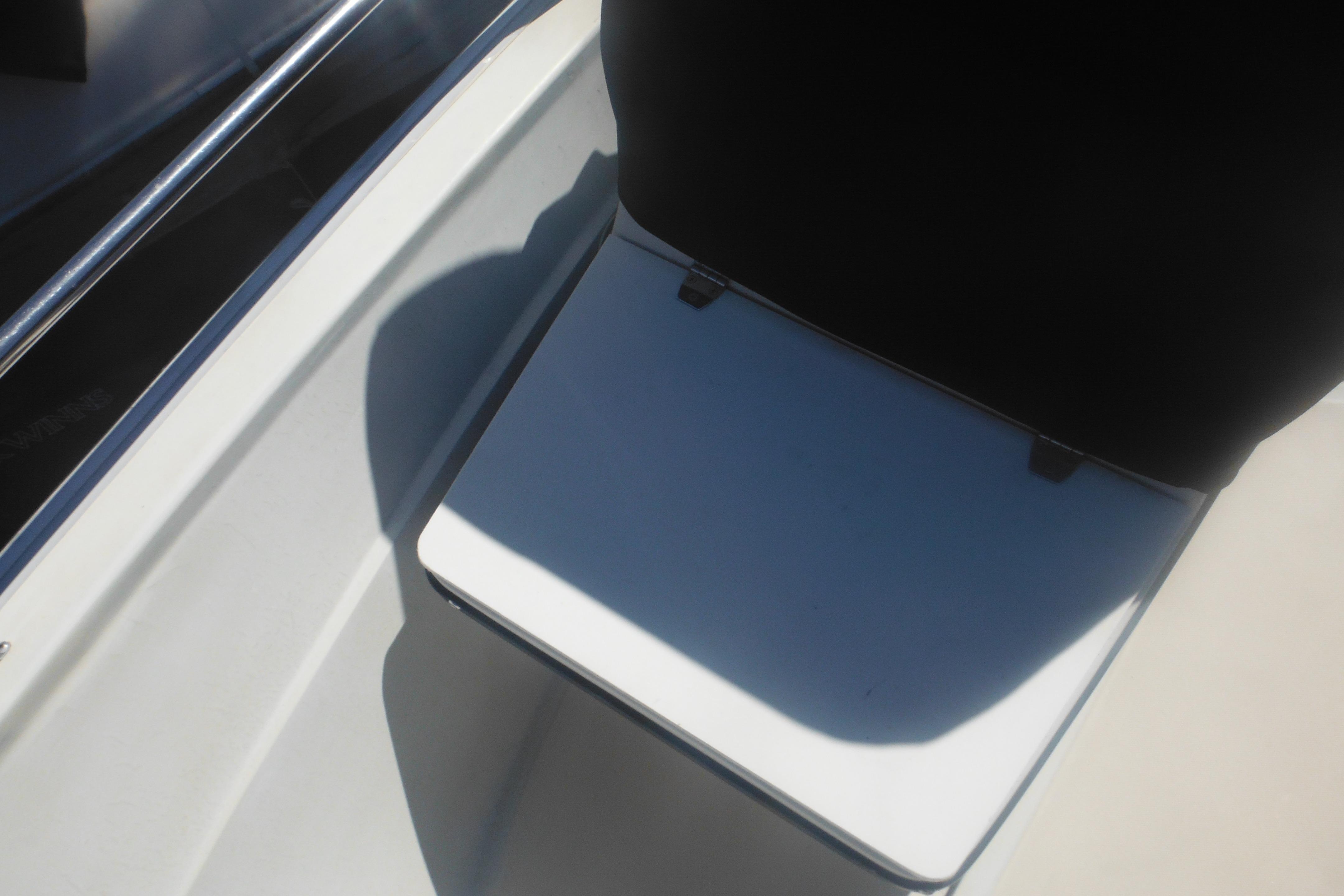 Interior view of a 1991 Boston Whaler 16 SL boat seat and railing.