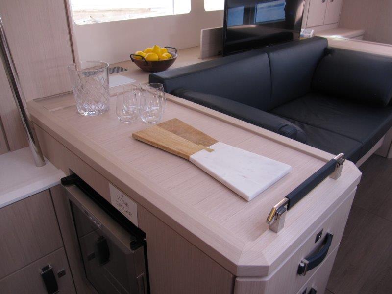 Modern interior of 2024 Jeanneau 60 yacht with kitchen and lounge area.
