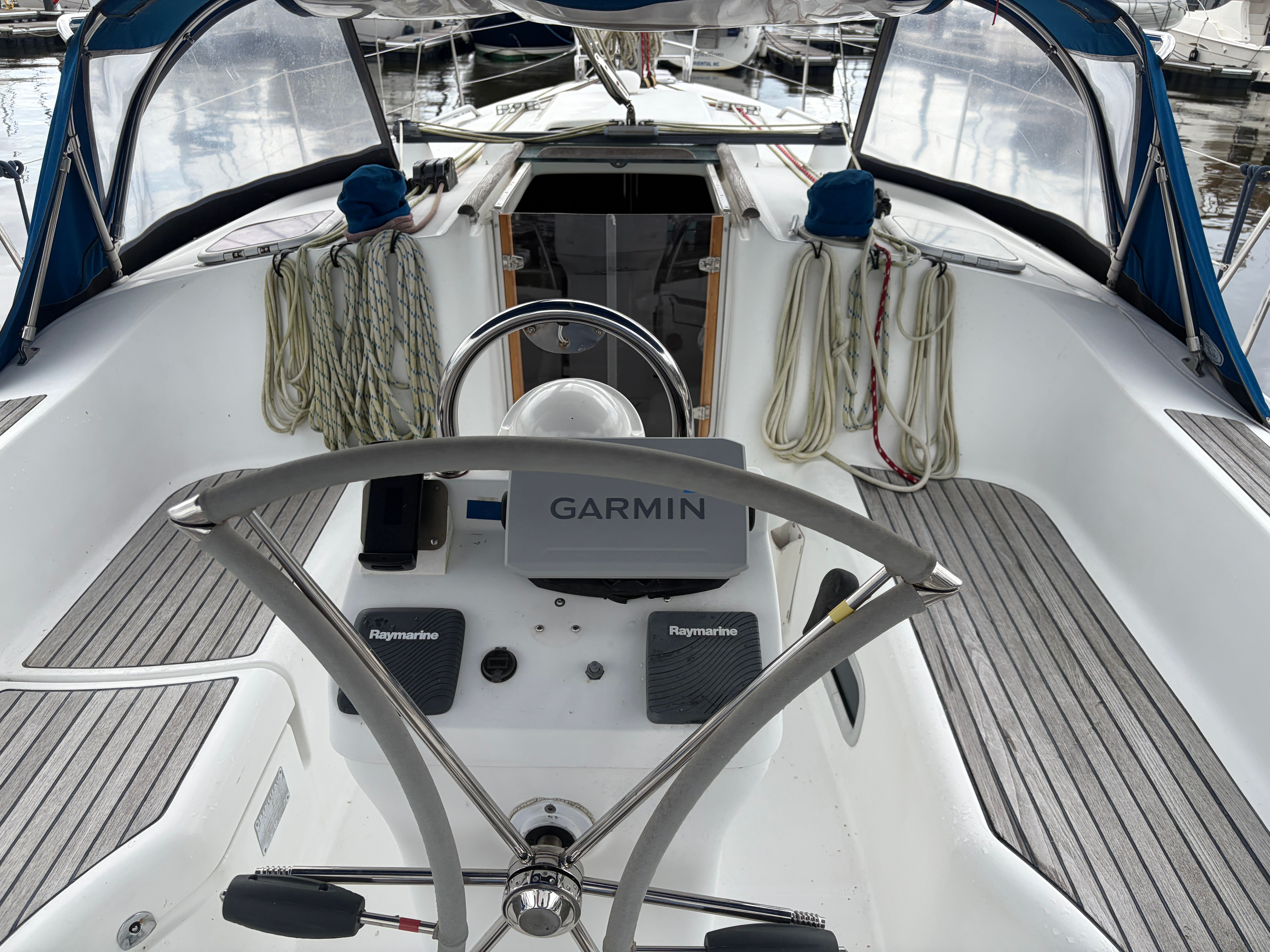 The cockpit of a 2000 Beneteau Oceanis 361 with a steering wheel and navigation system.