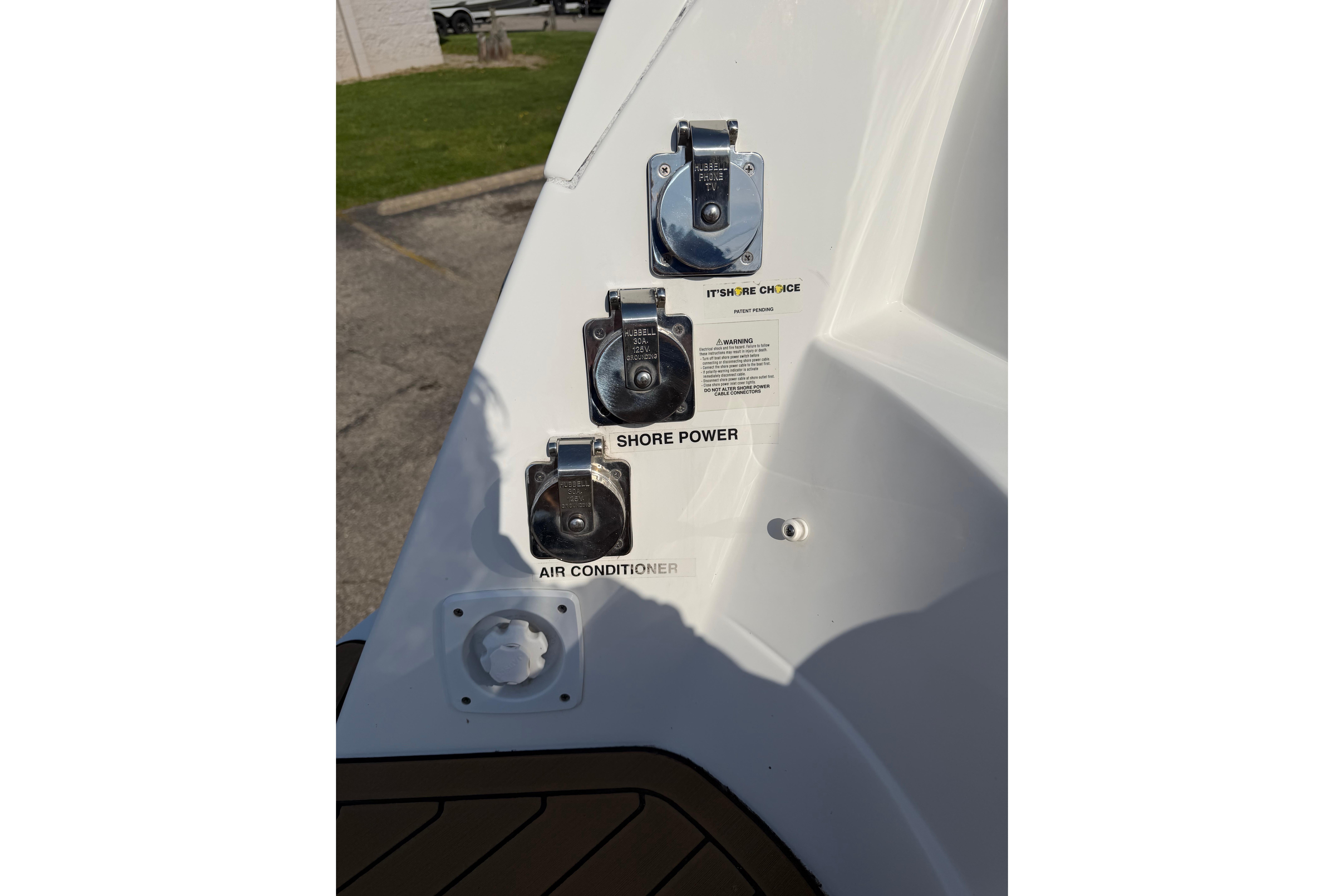 2019 Rinker EX 320 boat power connections: shore power and air conditioner outlets.