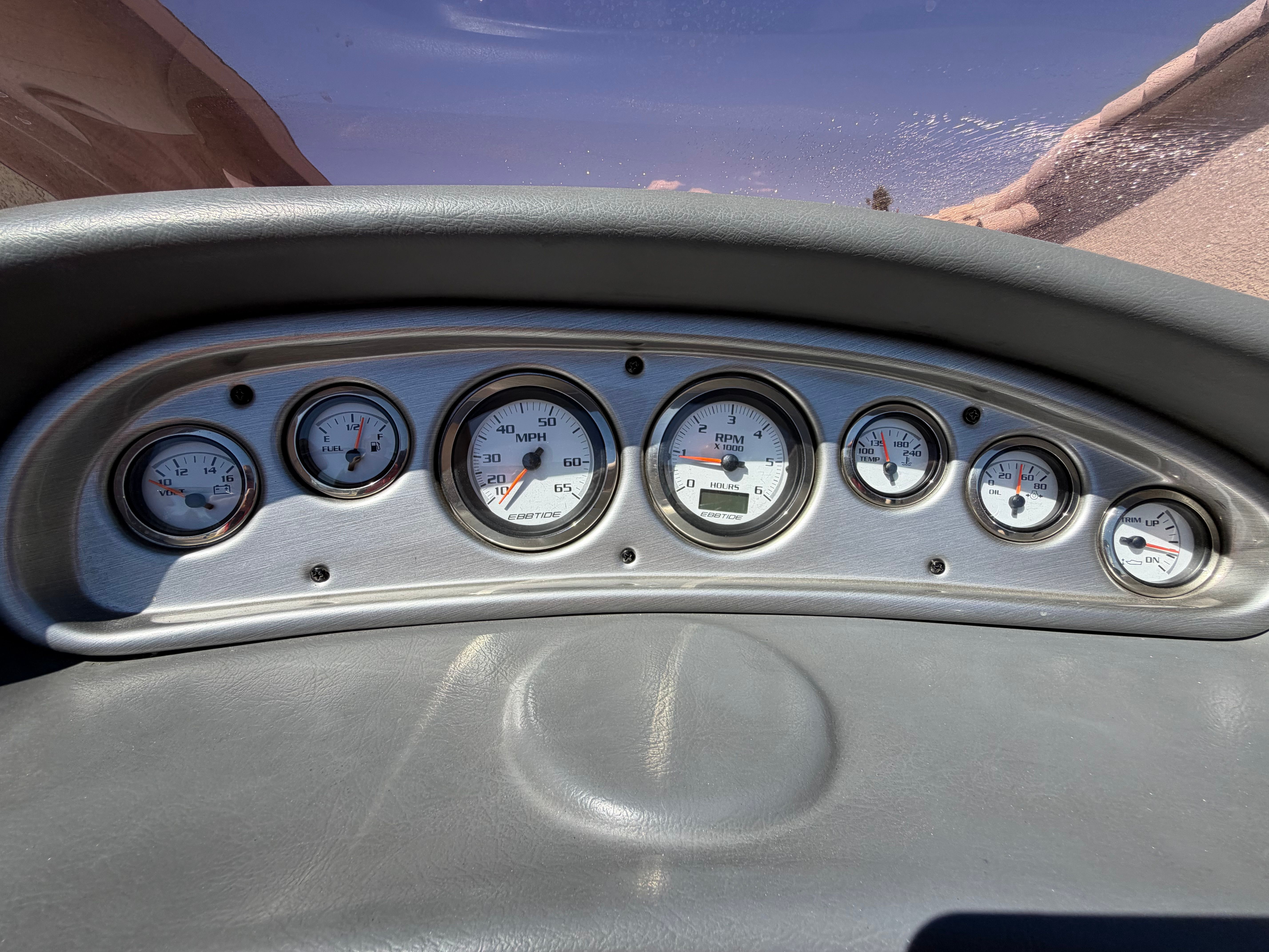 Dashboard of a boat with multiple gauges.